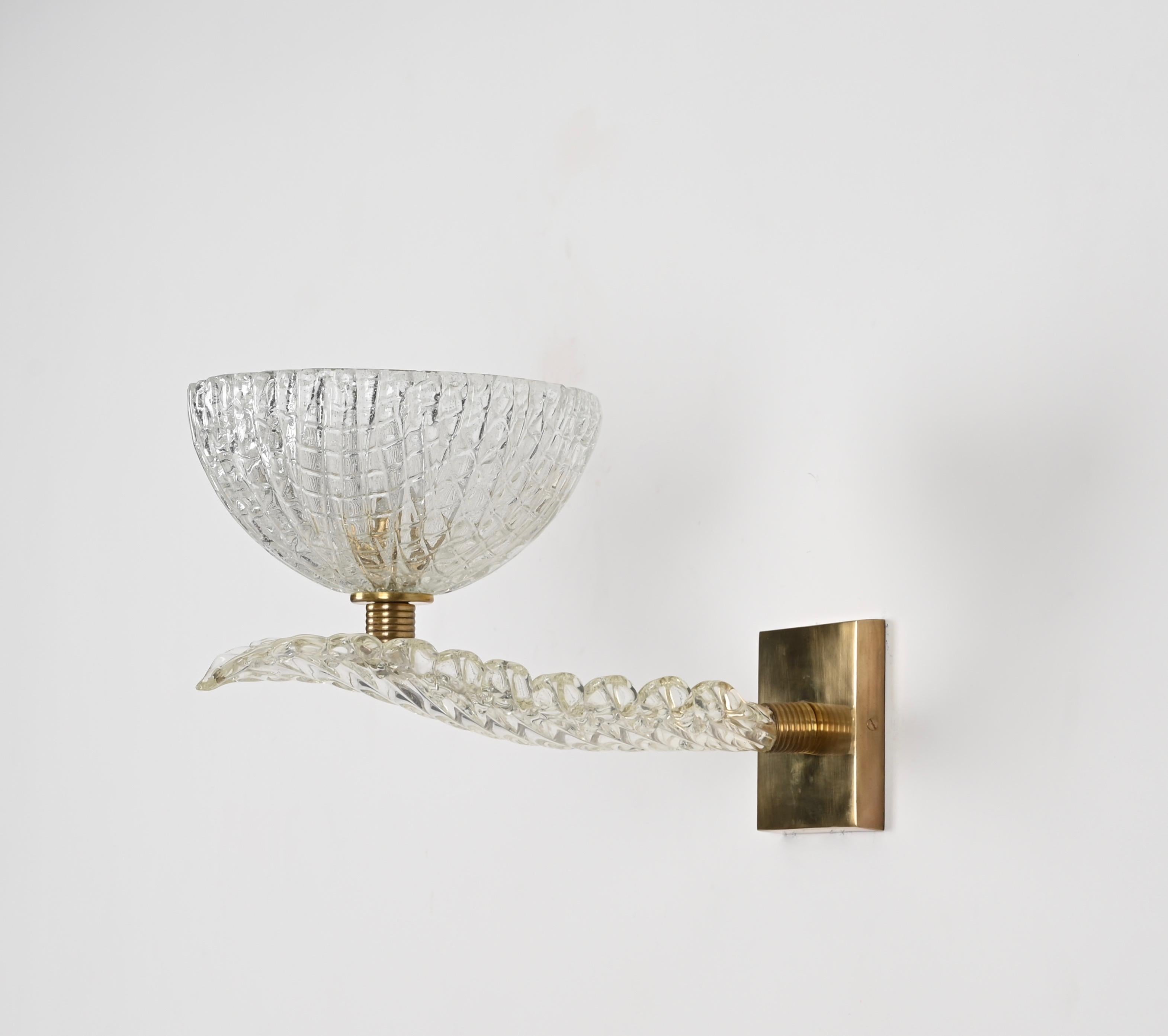 Incredible pair of enormous sconces fully hand-made in Murano mouth blown crystal glass and solid brass. These mind-blowing wall lamps were designed by Barovier made in Murano, Italy during the 1950s.

These incredibly rare sconces feature a big
