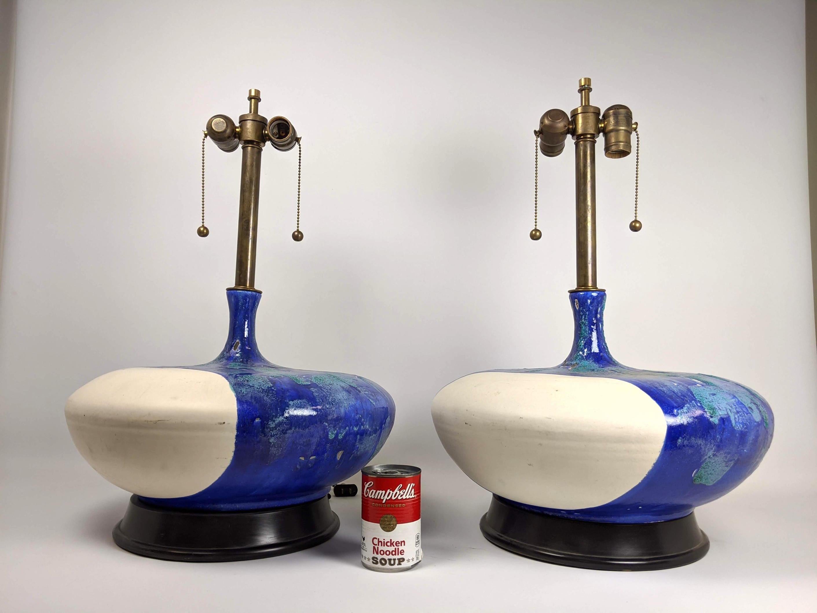Pair large pottery table lamps. Wide bases with blue lava glaze. Very artful design and we love the look and texture the thick glaze. Shades are not included.
   
   
