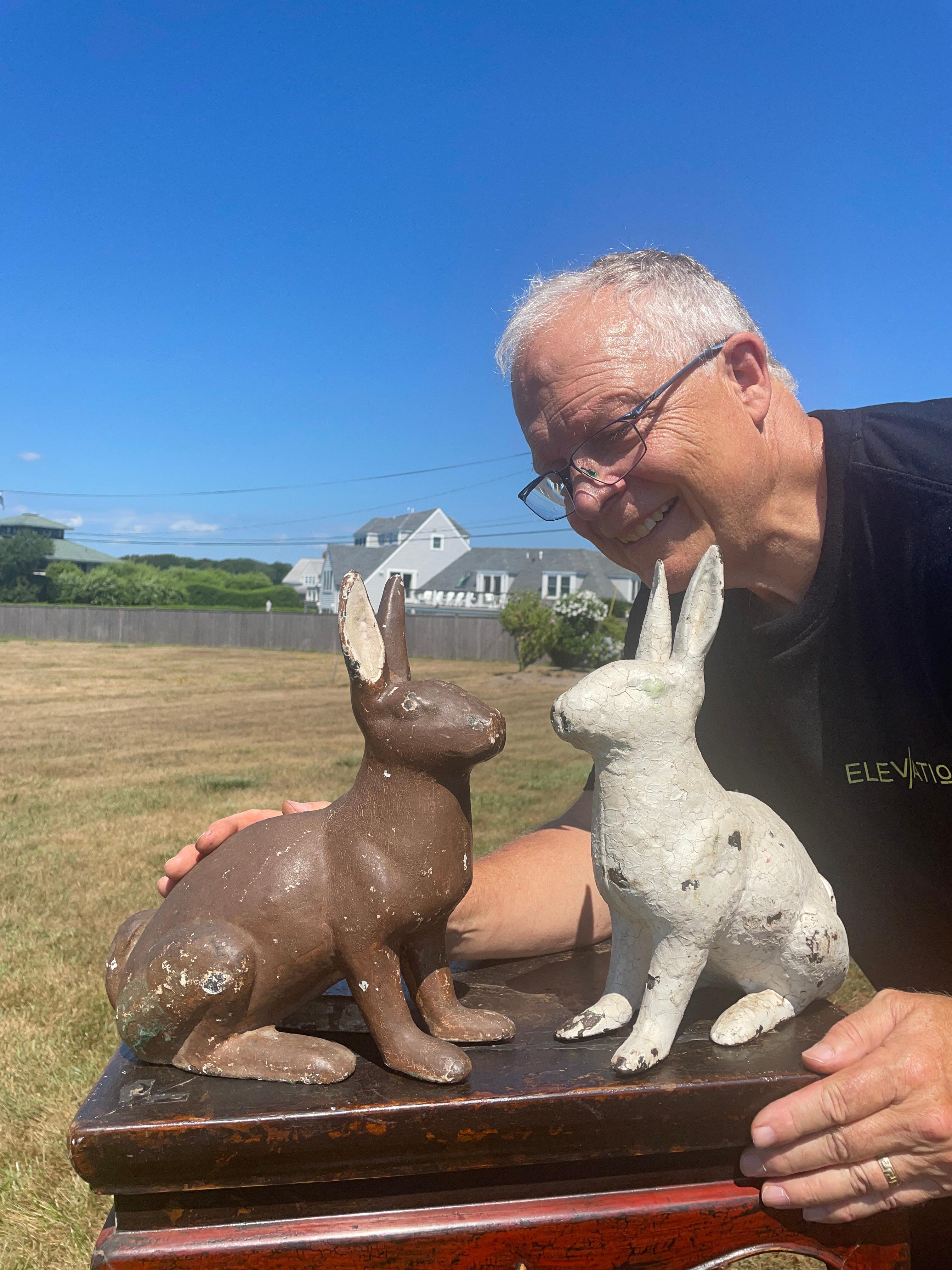 Rare pair white and chocolate hand painted garden rabbits

A big handsome pair (2) old heavily hand cast rabbits in a realistic alert 