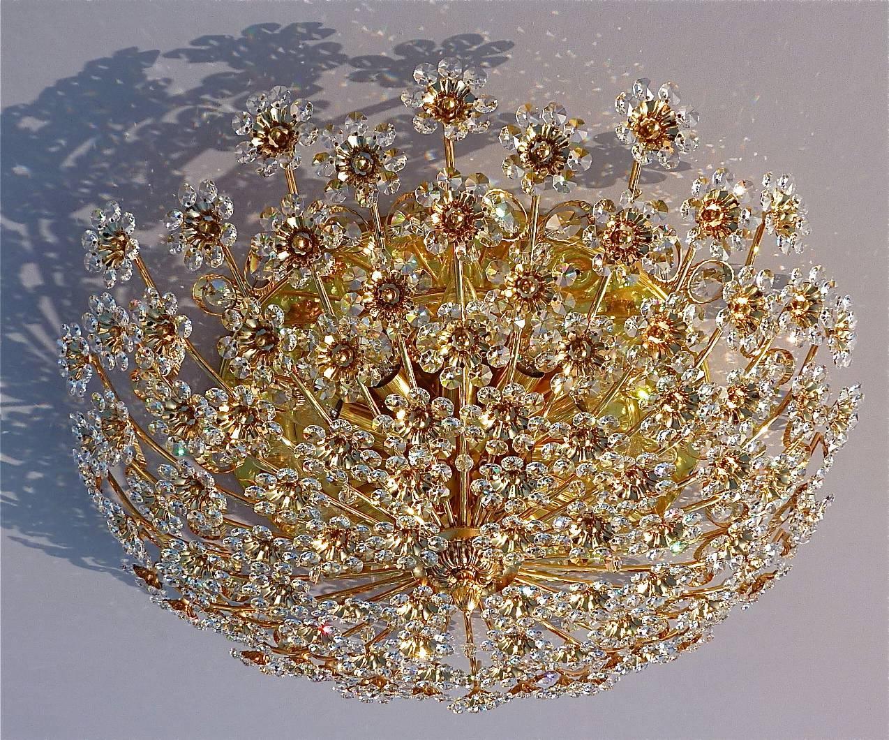 Huge round gilt brass metal crystal glass flush mount chandelier made by Palwa, Germany, circa 1960-1970, documented in the Palwa sales catalog and signed at the back with Palwa company label with model number. The gorgeous ceiling light has lots of
