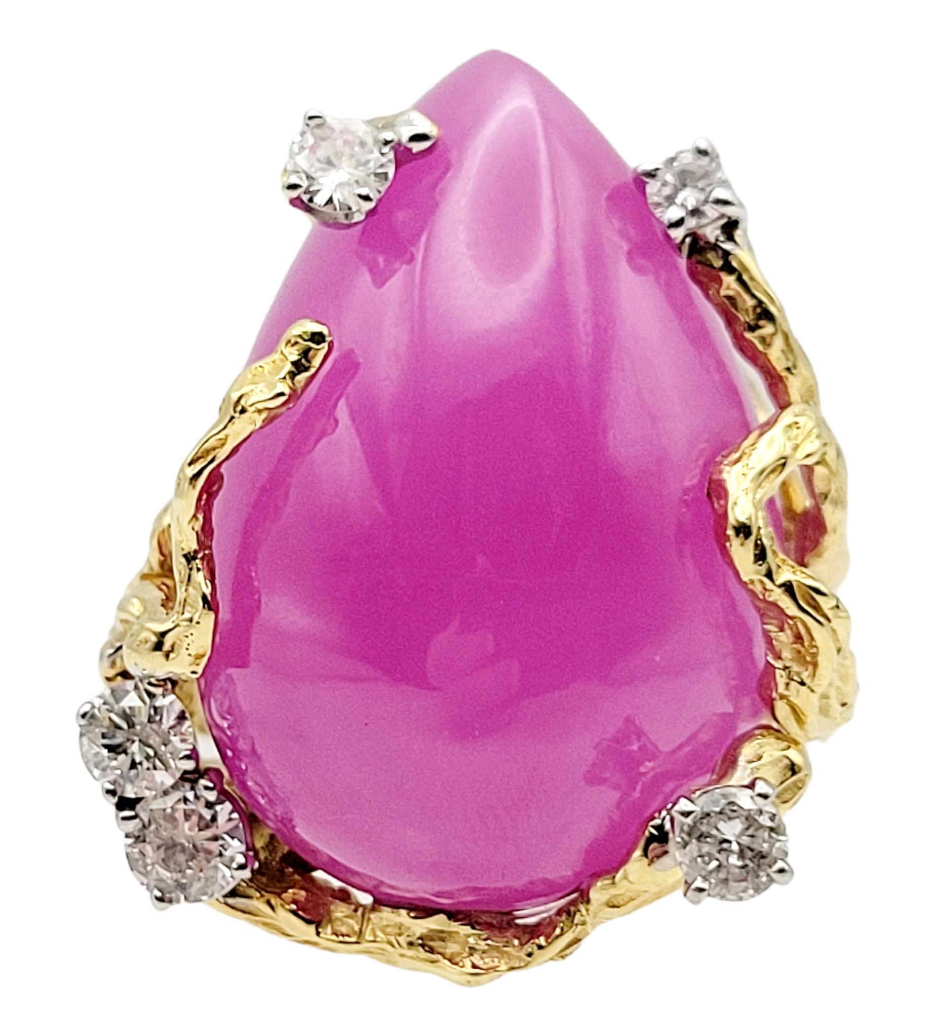 Ring size: 6.75

This massive, colorful cocktail ring has all the wow factor you've been looking for! Striking in both size and color, this remarkable piece will not go unnoticed. 

The stunning pear cabochon lab created pink sapphire stone is an