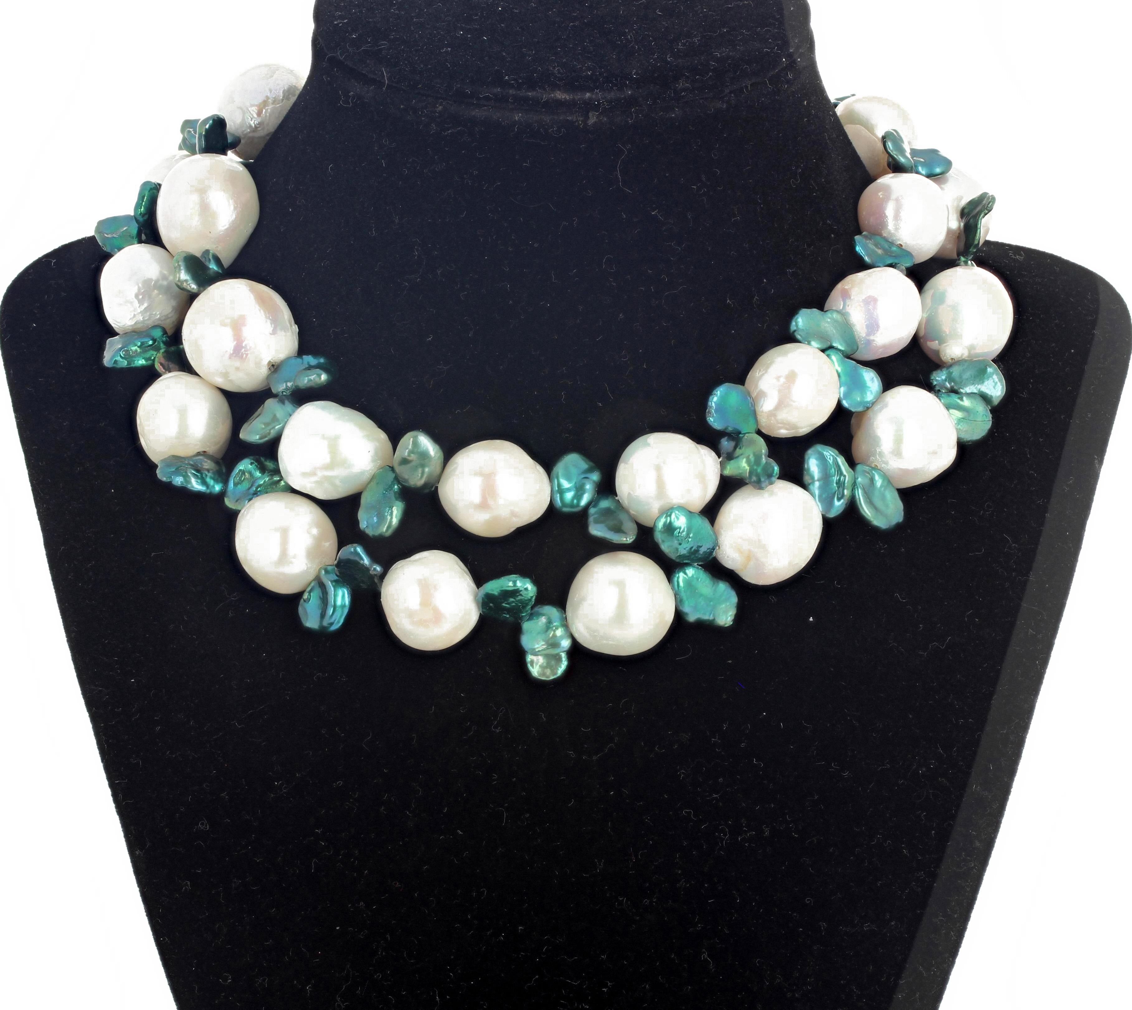 From 15mm to 20mm beautiful white freshwater cultured Pearls enhanced with petals of blue-green tone peacock Pearls set in a handmade necklace 29 inches long.  The clasp is also freshwater cultured Pearl.   