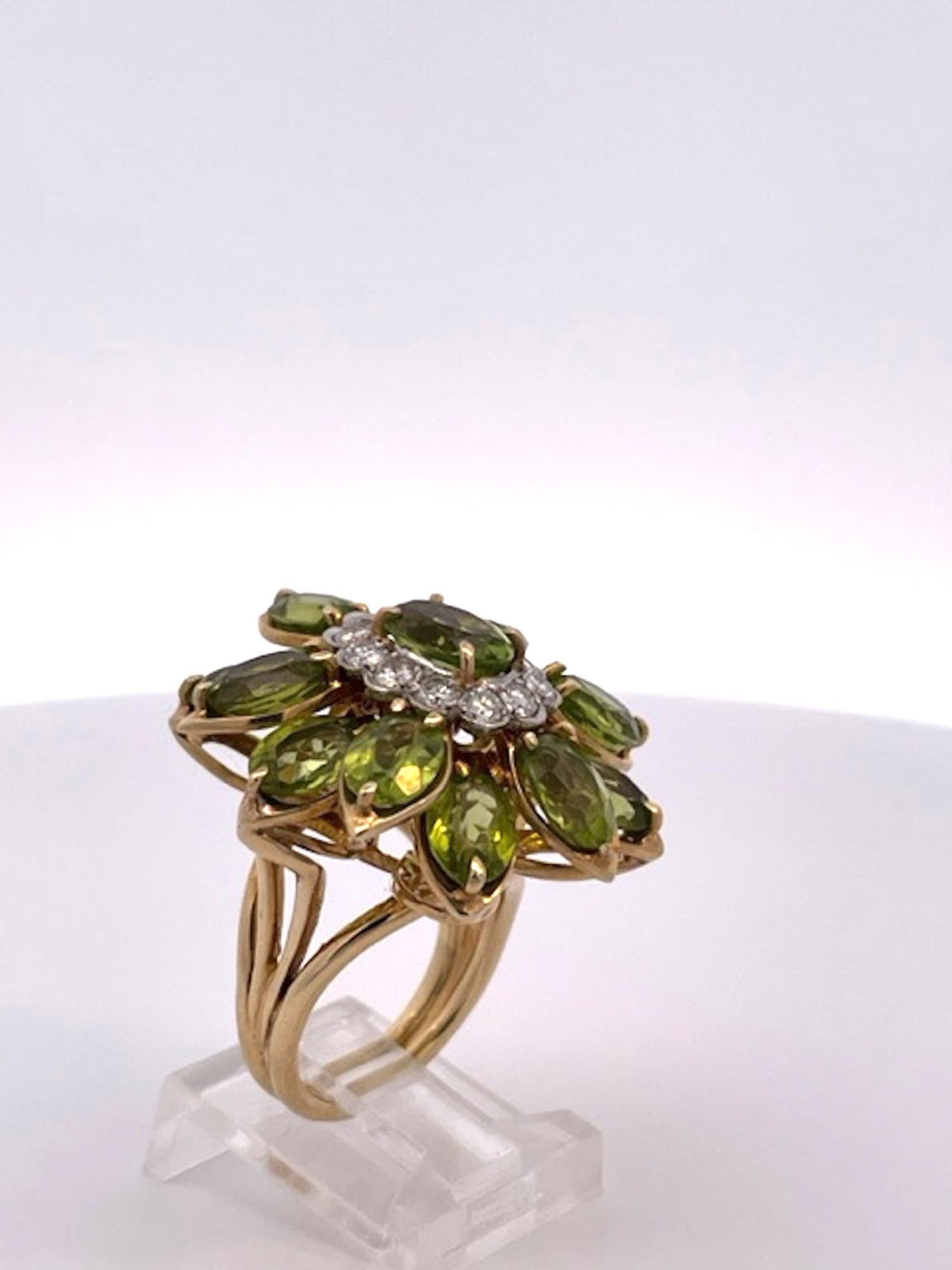 This huge Peridot Diamond Glamour Ring is a magnificent example of a cocktail statement ring. It is made of 14K yellow gold with Marquise cut stones there are 12 stones all approximately 1 carat each to total 12 carats.  There is also a center stone