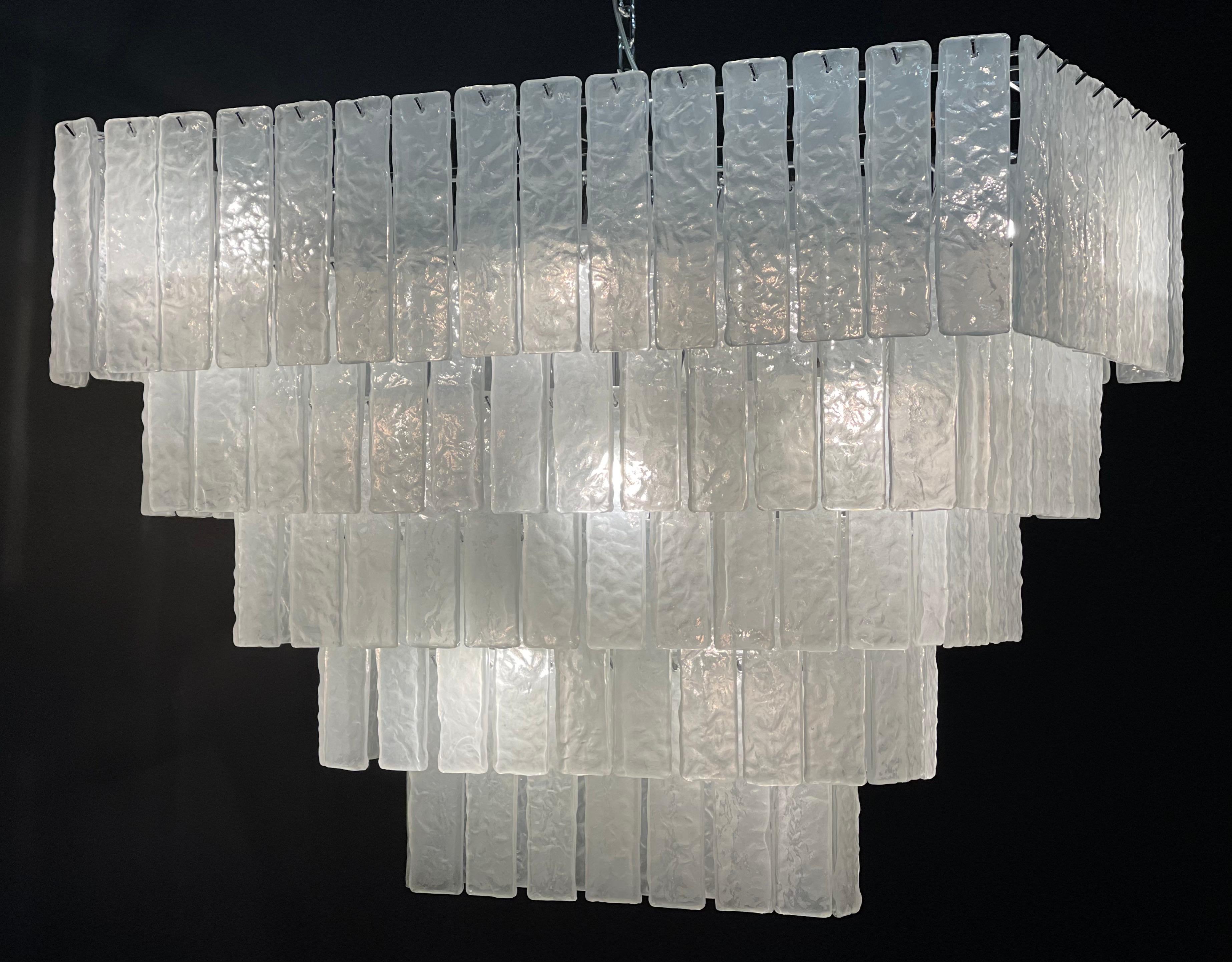 Huge rectangular five - tiered Murano glass chandelier by Venini, Italy, circa 1980s.
This heavy height- quality light fixture is made of 160 Murano glass elements hanging on nickeled metal frame.
Socket: 12 x plug bulbs ( LED)
Weight: circa 130