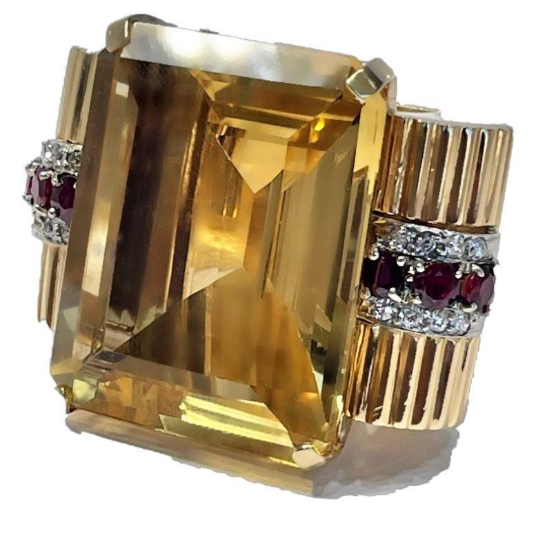 This huge, Retro period ring is certainly unique to the genre, not only for it's distinctive beauty but also for it's immense scale. The center Golden Citrine weighs approximately 100ct and is flanked by six natural rubies with a total approximate