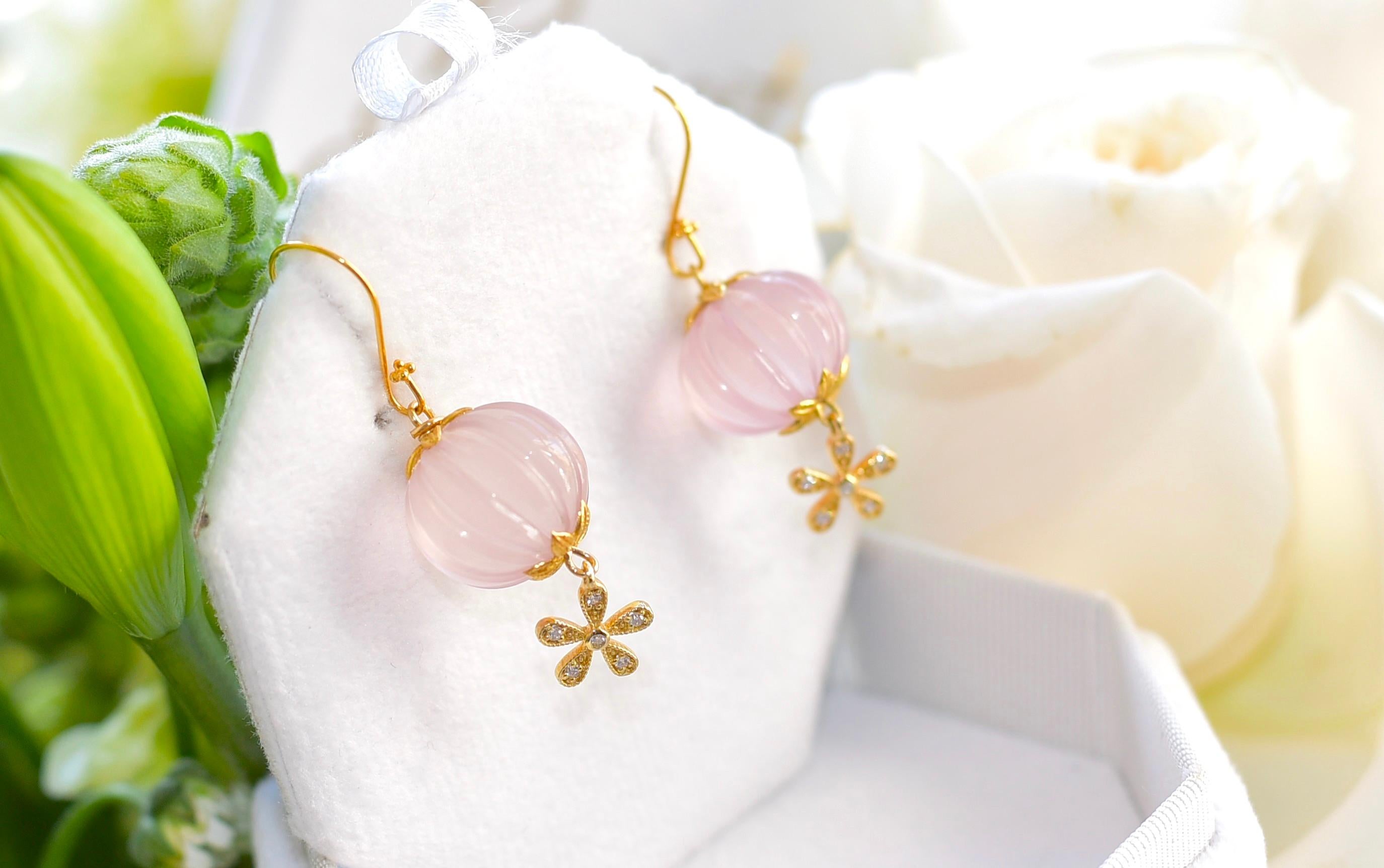 If you like Rose Quartz and a feminine look then this simple and beautiful piece of jewelry is for you!
Rose Quartz Carved Melon Bead (15,5mm) with sparkling and cute 14K solid Yellow Gold Diamond 5 petal flower Charm. Absolutely lovely look and