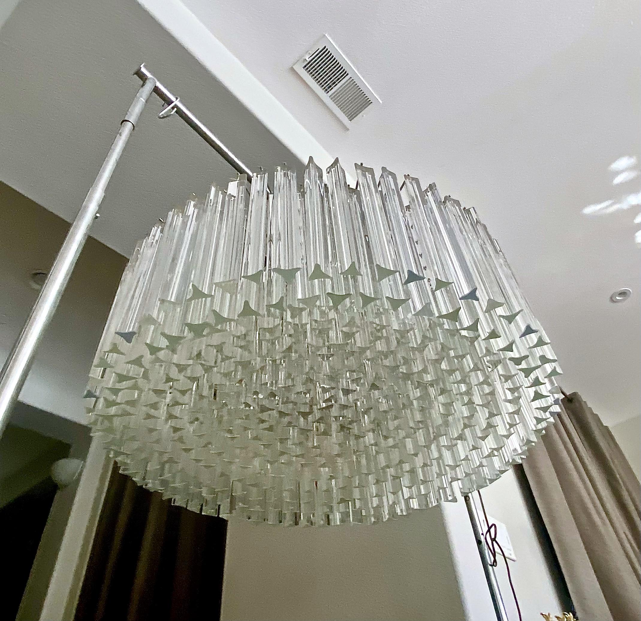 Huge round drum shaped Venini triedi crystal prism chandelier. Multiple layer prisms creating an eye catching concave effect. Chrome plated steel frame with 9 