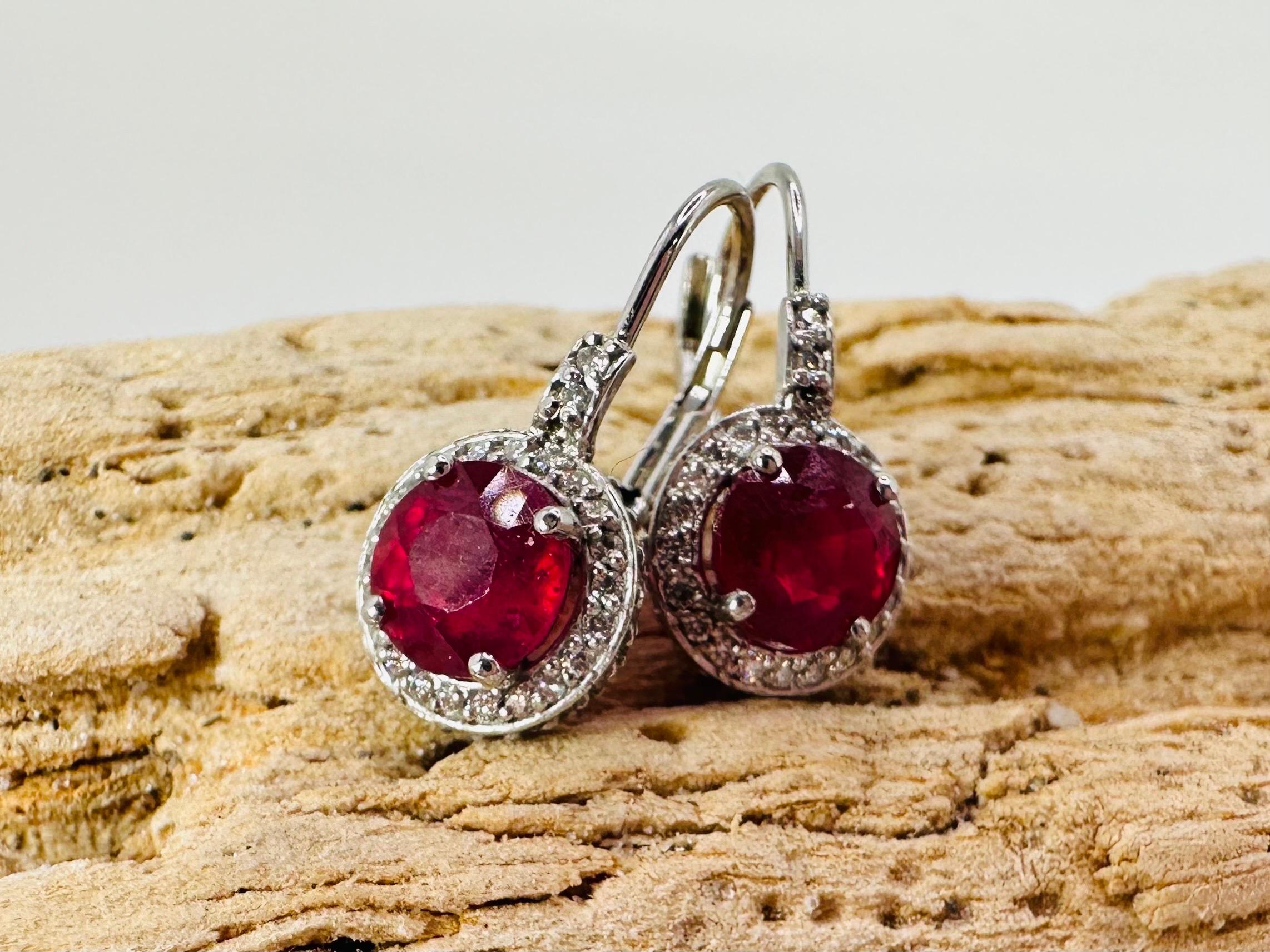 Stunning ruby and diamond earrings in 14KT white gold, the rubies sparkle with red wine color which is rare for this size. Rubies are treated with heat only.

GOLD: 14KT white gold
NATURAL DIAMOND(S)
Clarity/Color: VS-SI/F-G-H
Carat:1.04ct

NATURAL