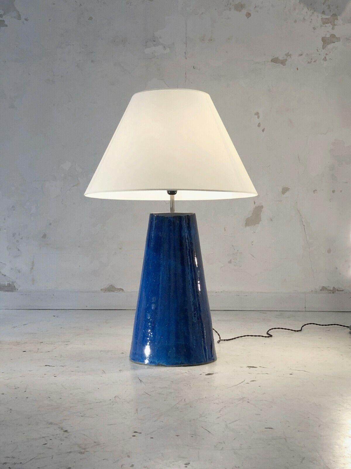A spectacular very large conical floor or table lamp, Post-Modernist, Free-Form, Memphis, Constructivist, Bauhaus.... in thick blue enameled ceramic, topped with a large lampshade, without signature or monogram, to be attributed, France 1980.

SOLD