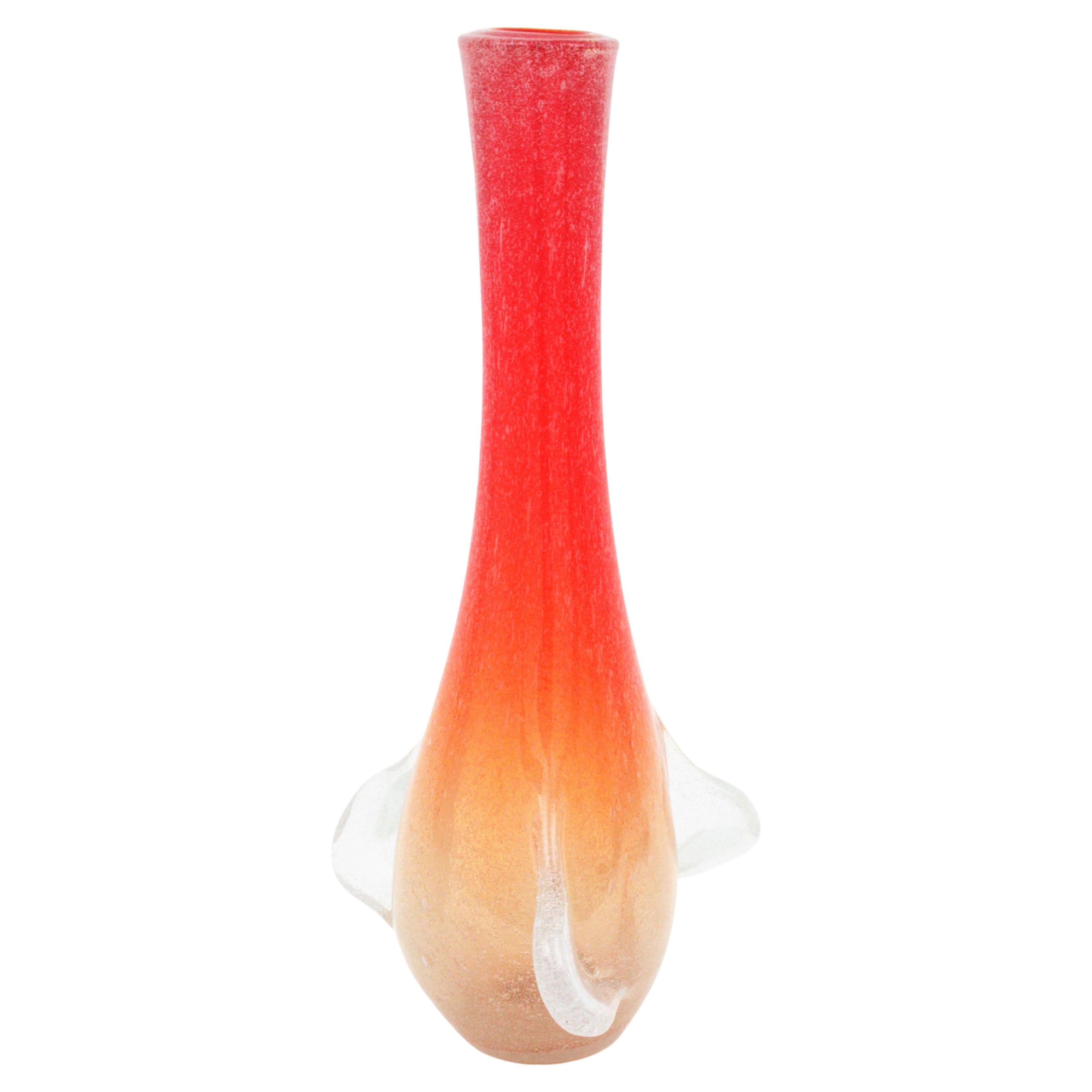 Oversized hand blown Murano Art glass vase with inner air bubbles. Attributed to Seguso Vetri d'Arte. Italy, 1950s.
This eye-catching Murano glass tall vase is made in shades of red orange to clear glass and pulled details. It is made with the
