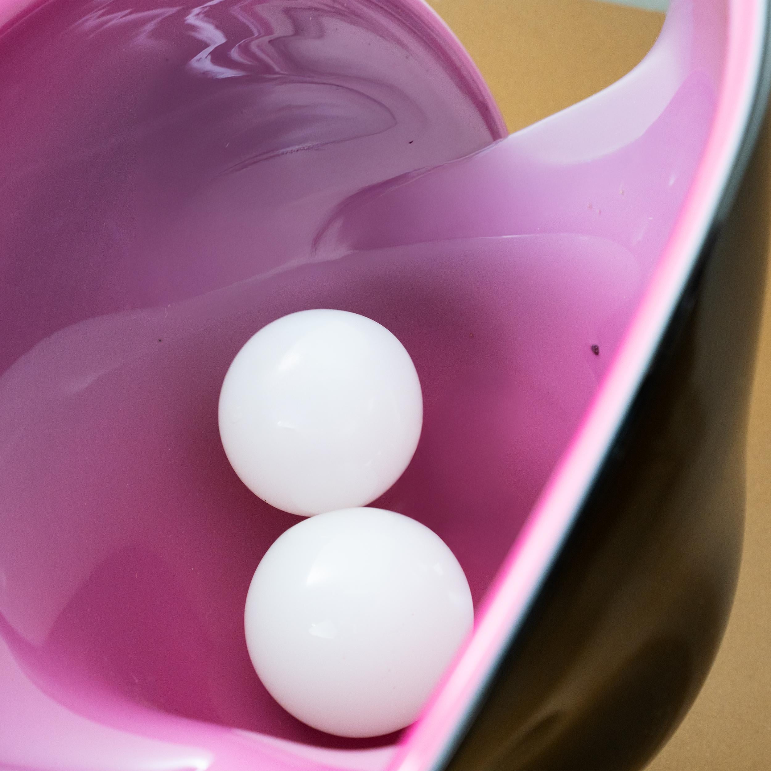 Impressive in size and shape, this two-tone, black and rich pink, shell bowl or vase or vessel has turned down sides and retains its original sticker. As seen in the images, it contains two murano glass pearl and it can be displayed in two ways as