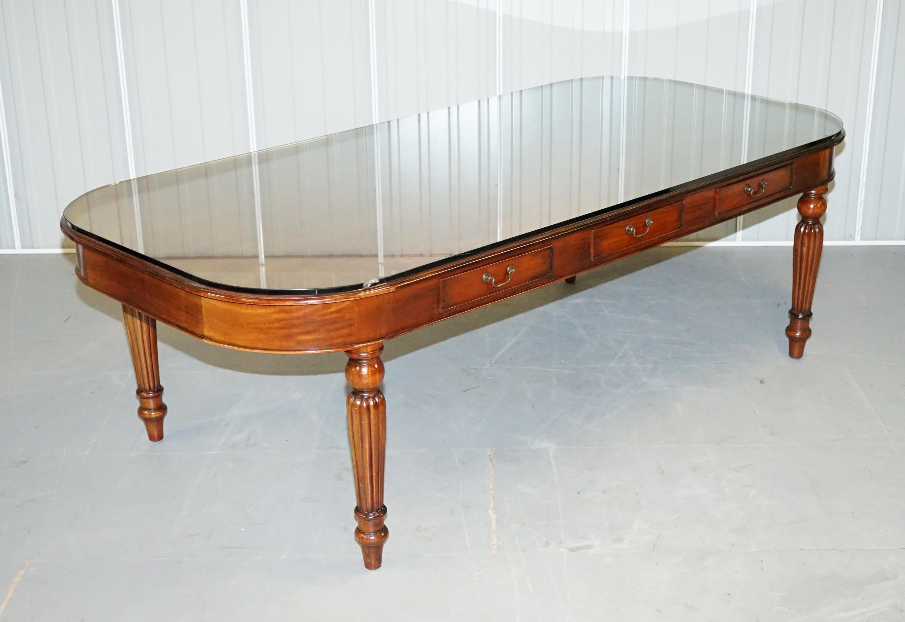 We are delighted to offer for sale this large 10-12 person six drawer Regency style mahogany dining table with thick glass top

A very well made and quite grand dining table, it comes with an exceptionally thick glass top, the legs to the table