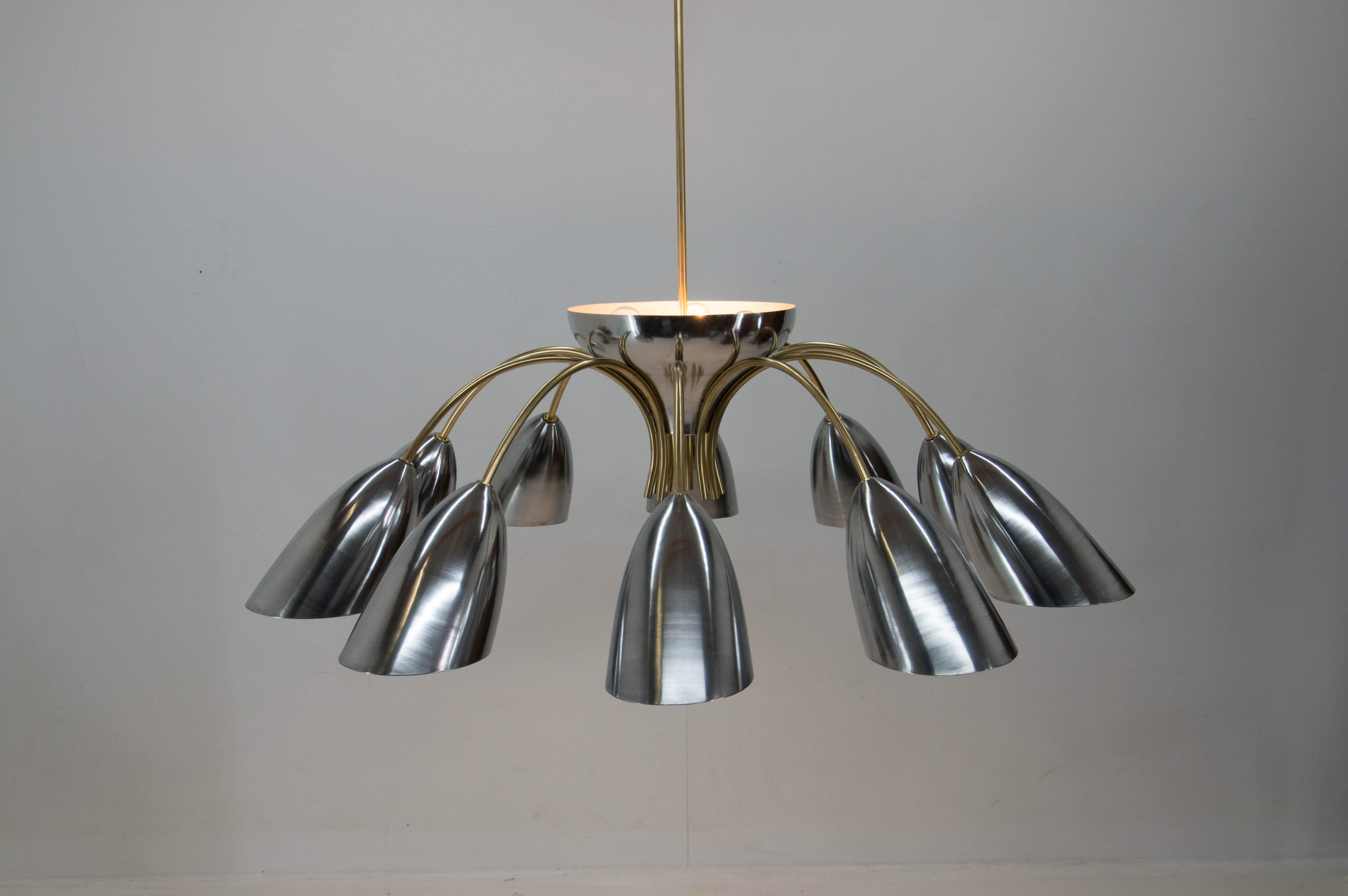 Extraordinary huge Space Age chandelier custom made in 1960s. Only few pieces were made for representative purposes in Czech factory. This piece was carefully disassembled, cleaned, the steel arms repainted to the original brass color, aluminum