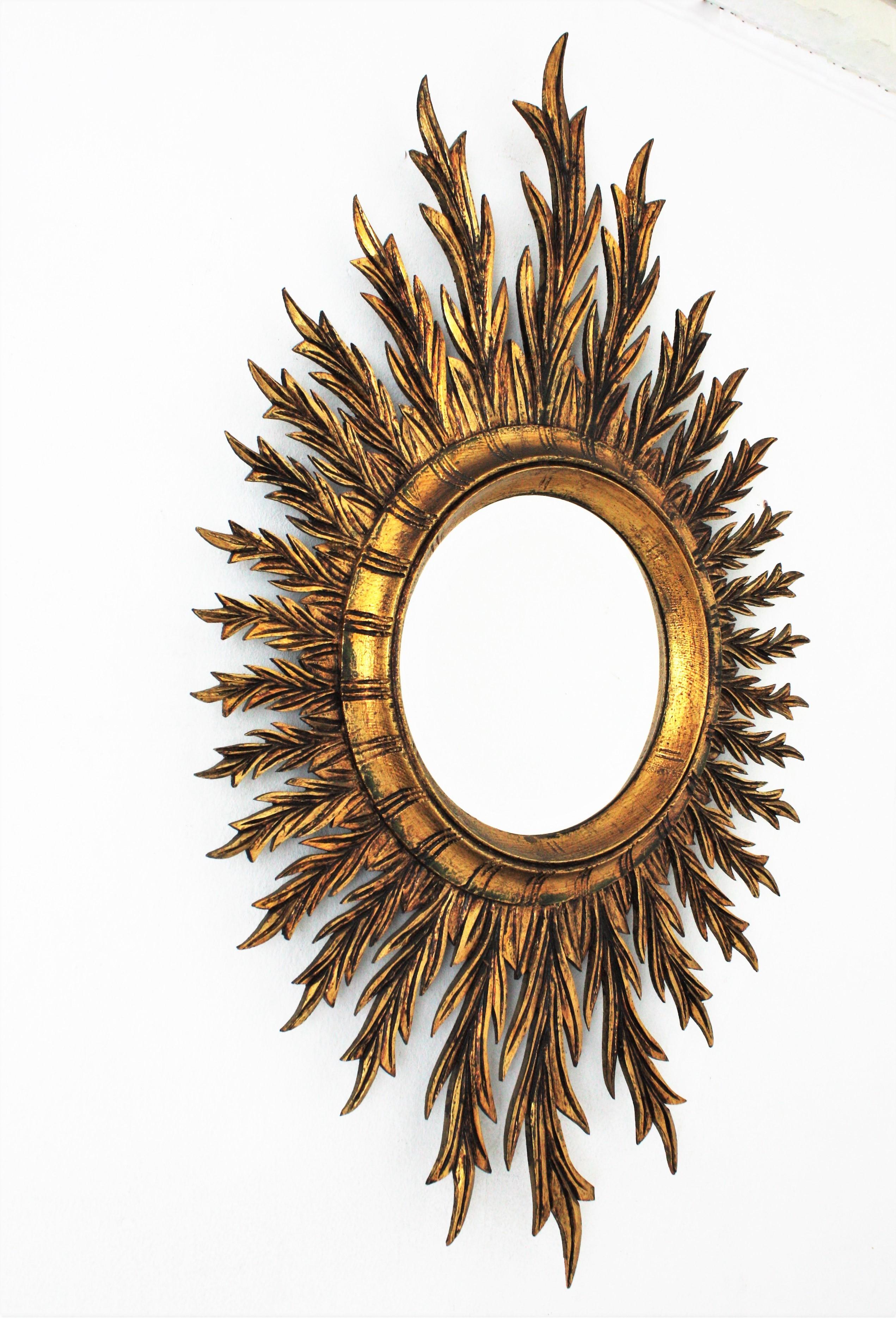 Mid-Century Modern Mid-Century Spanish Oval Sunburst Mirror in Carved Giltwood