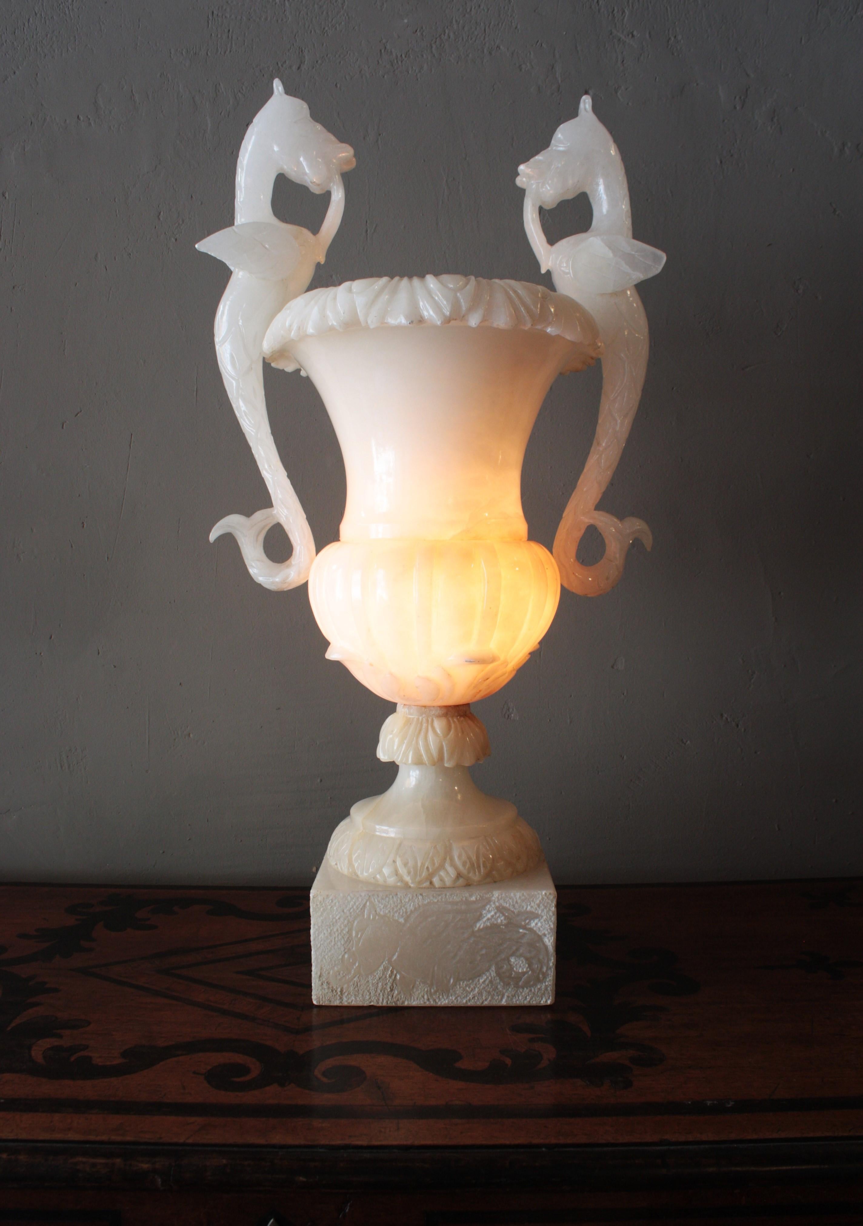 One of a kind Carved Alabaster Urn Lamp with Winged Dragon Handles, Spain, 1930s
This stunning Art Deco period alabaster lamp has an elegant neoclassical urn design with foliage carving details on the body and dragon motifs on the base. It has