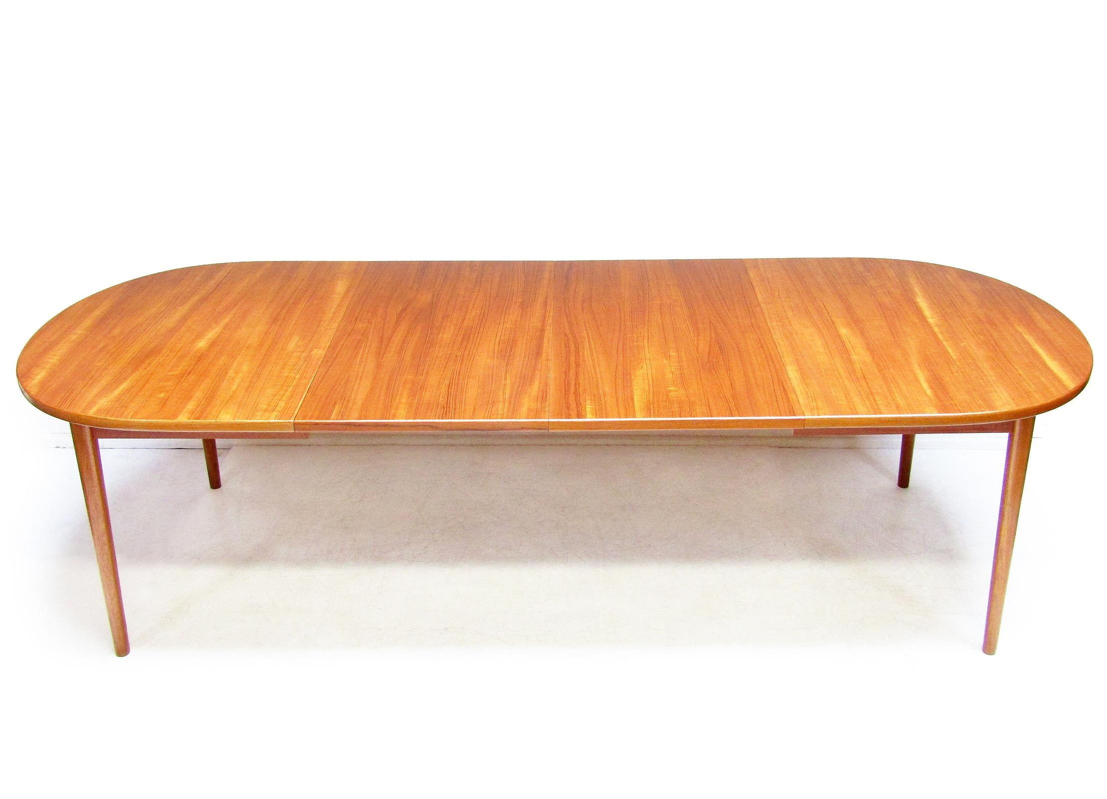 A beautiful 1960s extending dining table in teak by Swedish designer Nils Jonsson for Hugo Troeds.

In excellent restored condition it extends up to 265cm, seating up to fourteen diners.

The extension leaves can be neatly concealed within the