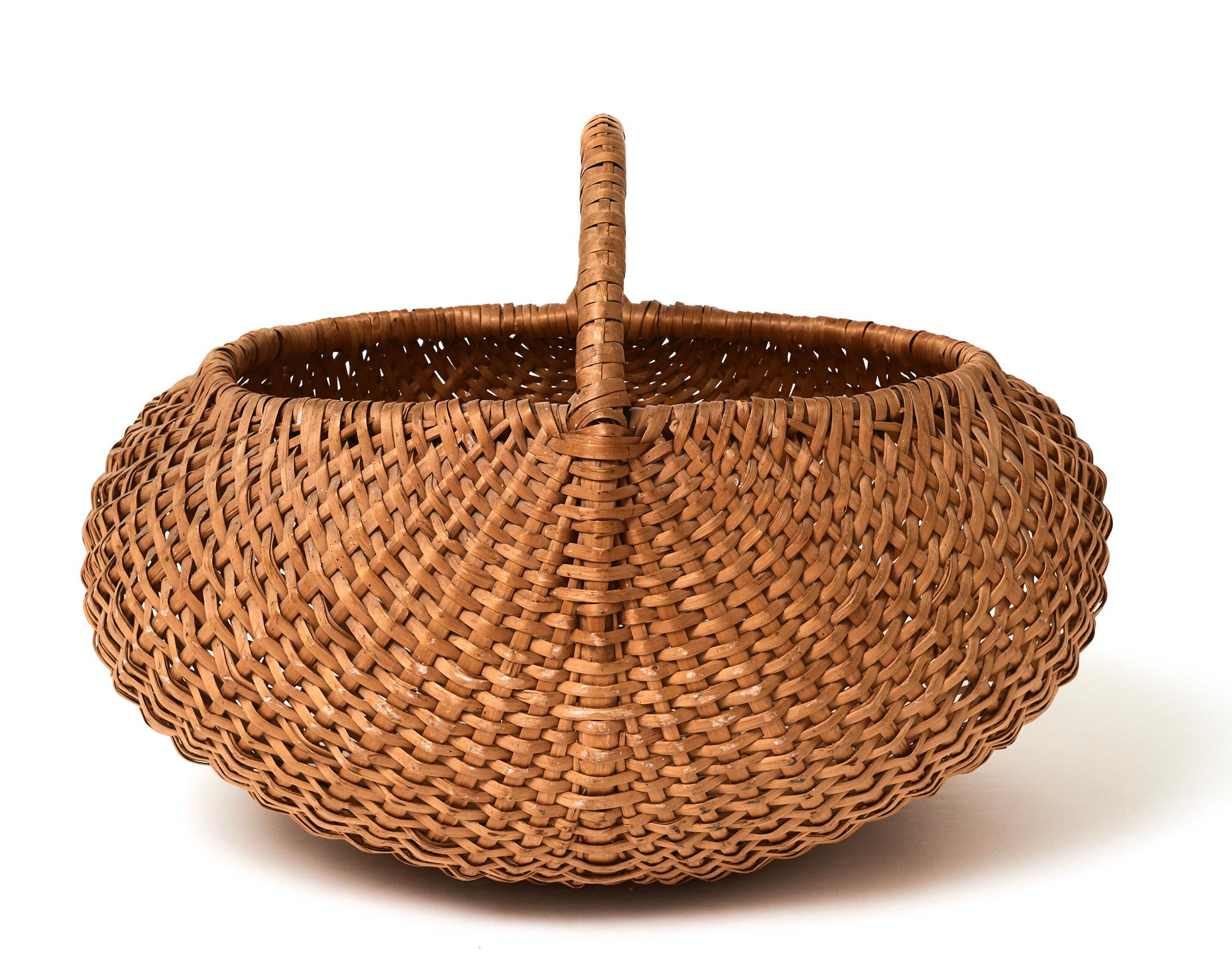A Swedish woven birch picking basket of oval form with a hoop handle, early 20th century. Unusually large size with a sculptural form. See image 8 for scale.