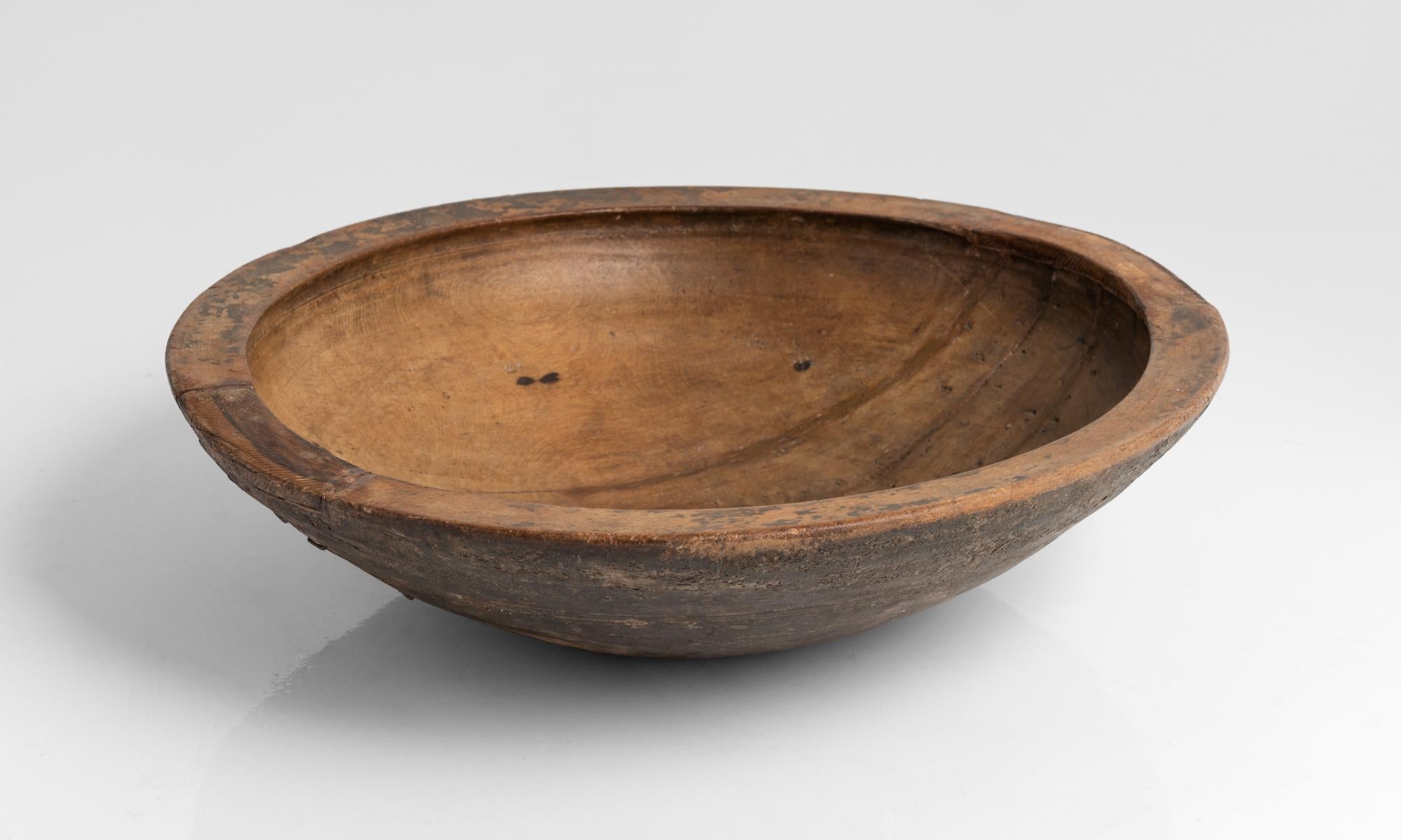 Huge sycamore dairy bowl, England, 19th century

Beautifully carved, with period repairs on bottom.