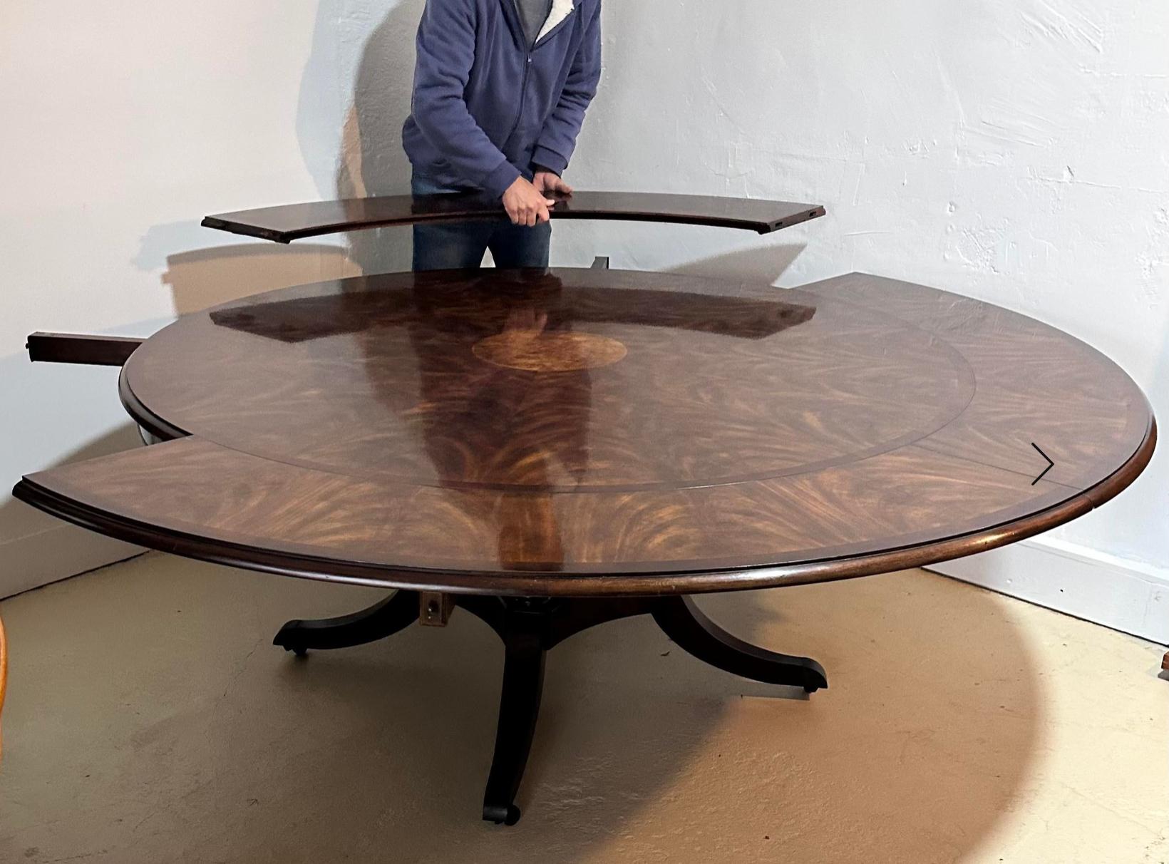 Huge Theodore Alexander Brook Street Modern Designer round dining extension table. It includes 4 detachable outer leaves that allow a larger or smaller size without sacrificing the round shape. It extends from 64” to 87”.