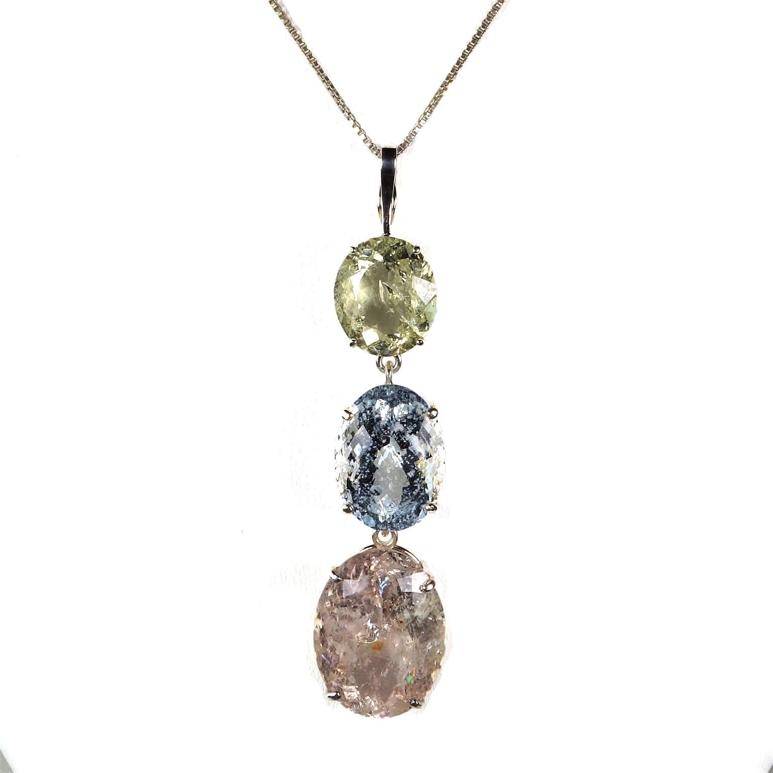 
Custom made, huge Beryl Pendant of Sterling Silver Baskets holding three Oval Beryls. The top is a yellow Heliodor, the middle is blue Aquamarine, and the bottom oval is a peachy-pink Morganite. The entire pendant is 2 7/8 inches from the top of