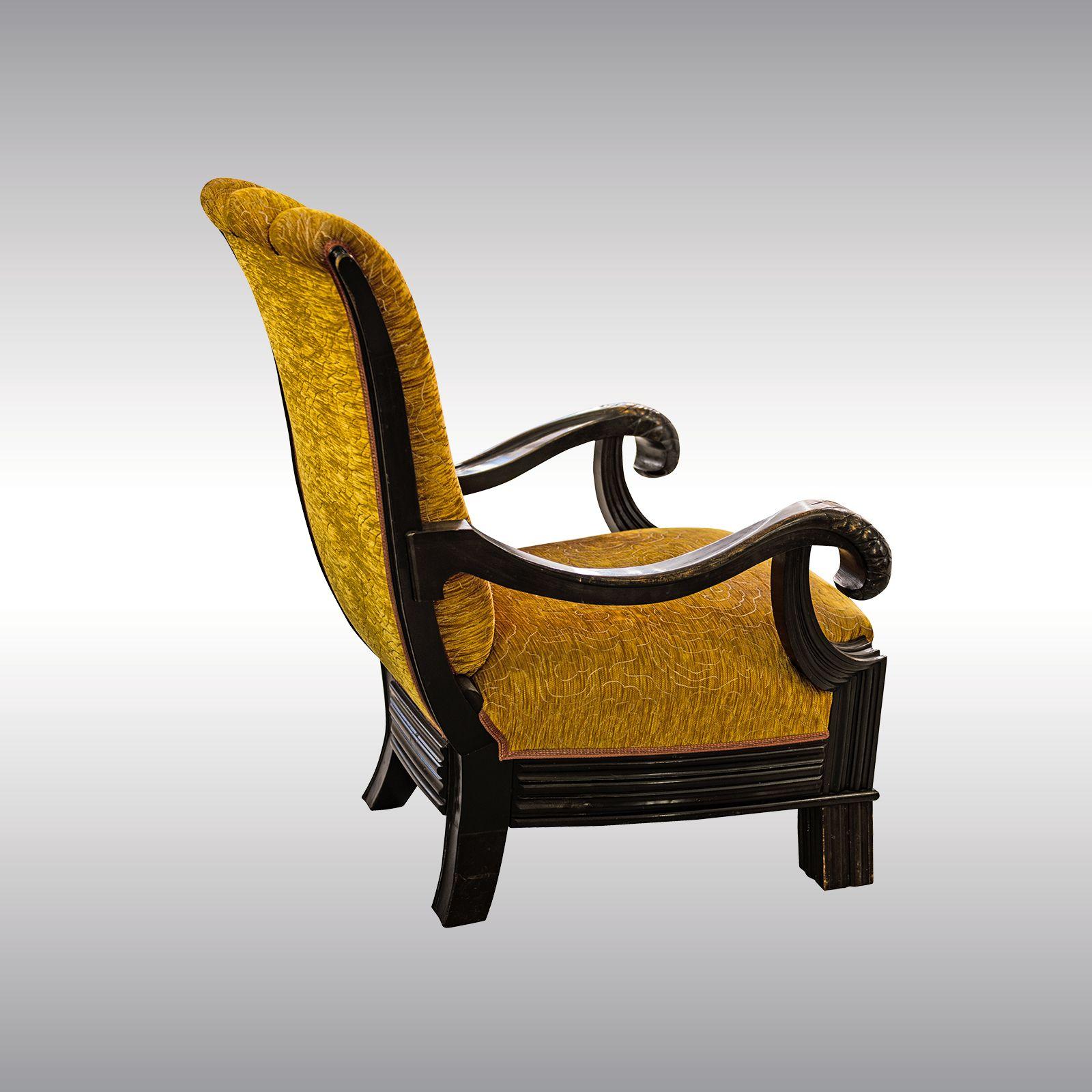 A big and rare throne-like armchair attributed to Otto Prutscher. Black-stained beechwood, carved and fluted. Floral fabric.