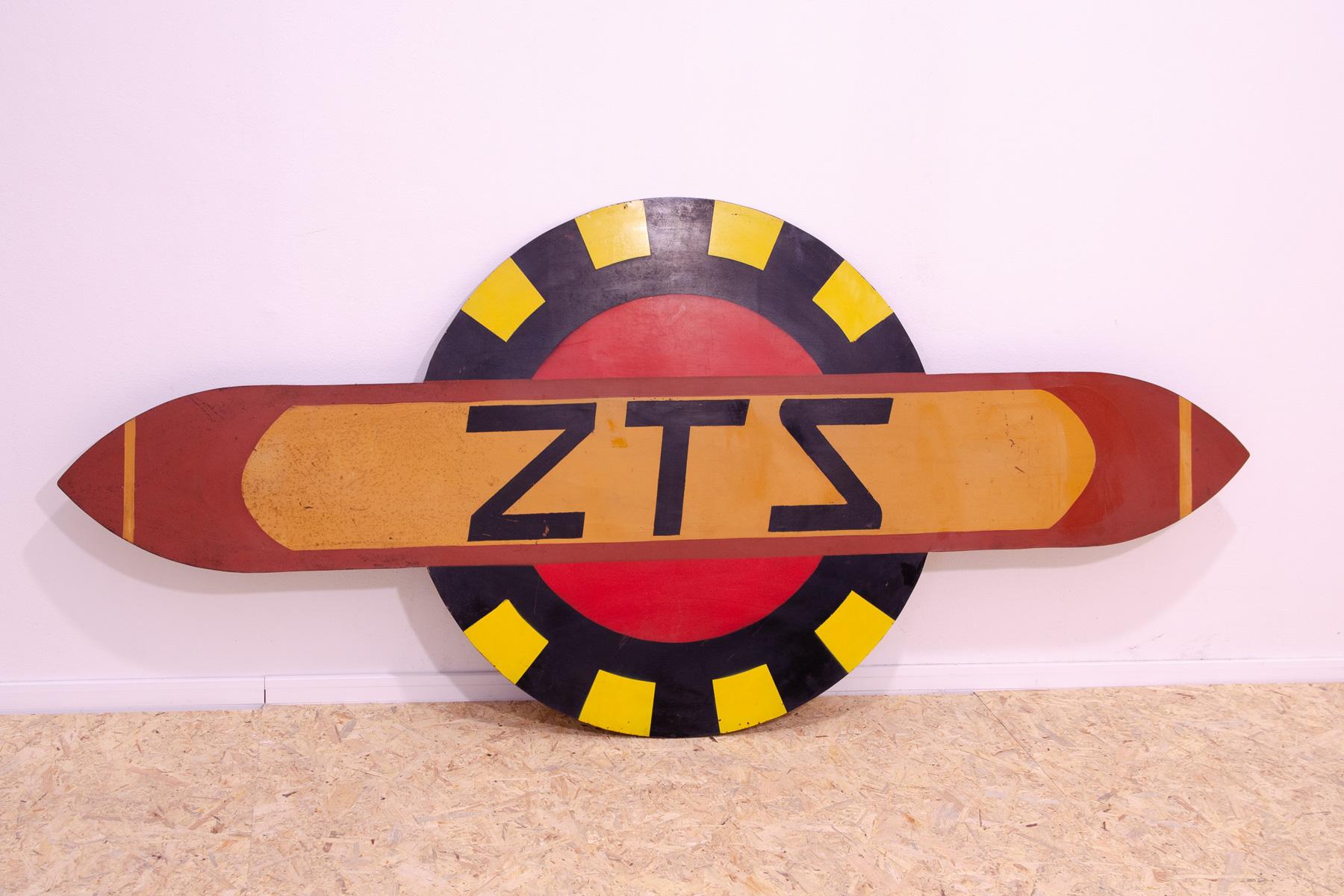 This hanging advertising sign is made of sheet metal and metal and features the letters ZTS. It was made in Czechoslovakia during the 80s and is in very good vintage condition. You can hang it on the wall with two screws.

 

Lenght: 200 cm

Height: