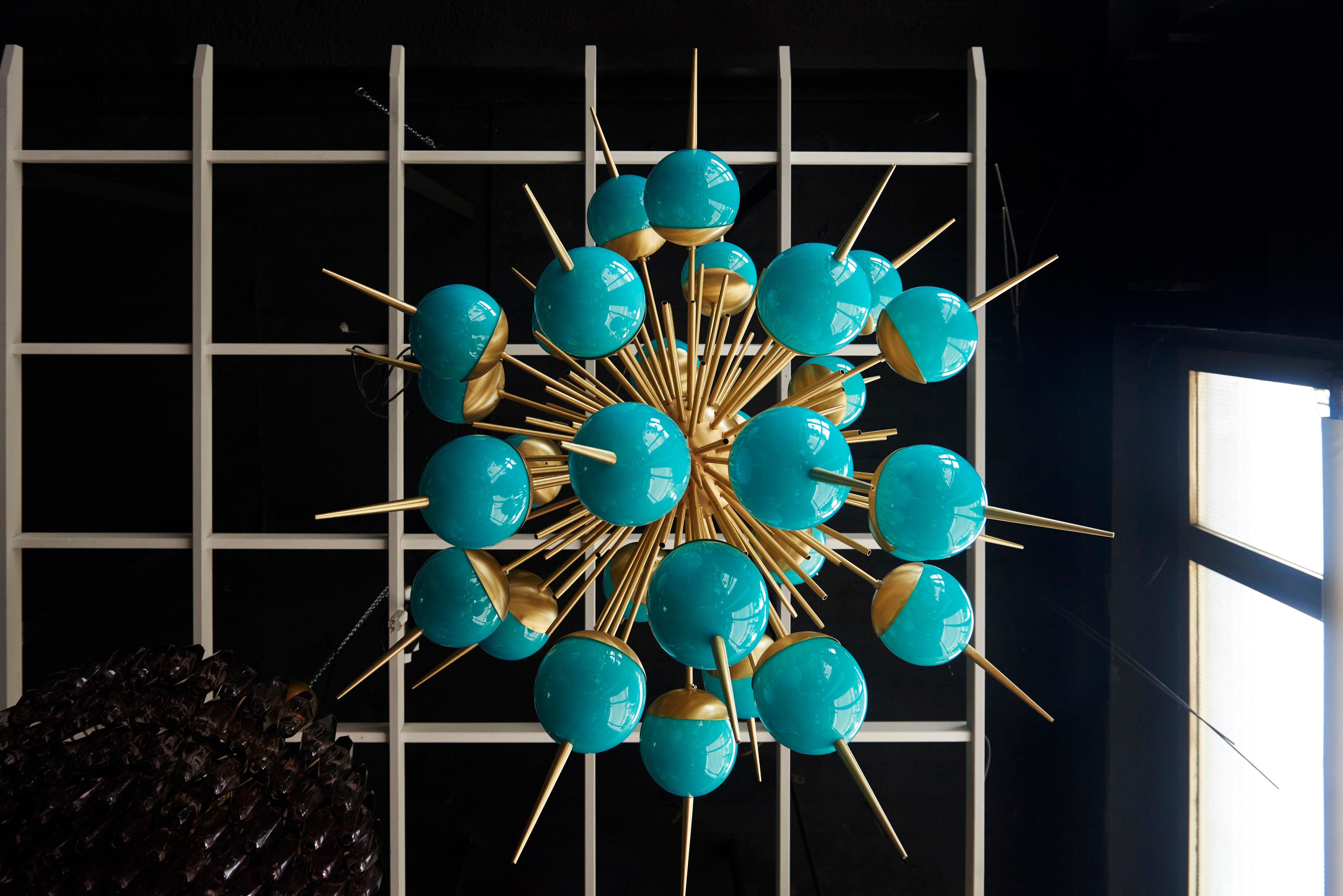 Exceptional huge turquoise color Murano glass and brass sputnik chandeliers. The chandeliers have a very impressing size and they are real eyecatchers in every room. The chandeliers are in excellent condition.

