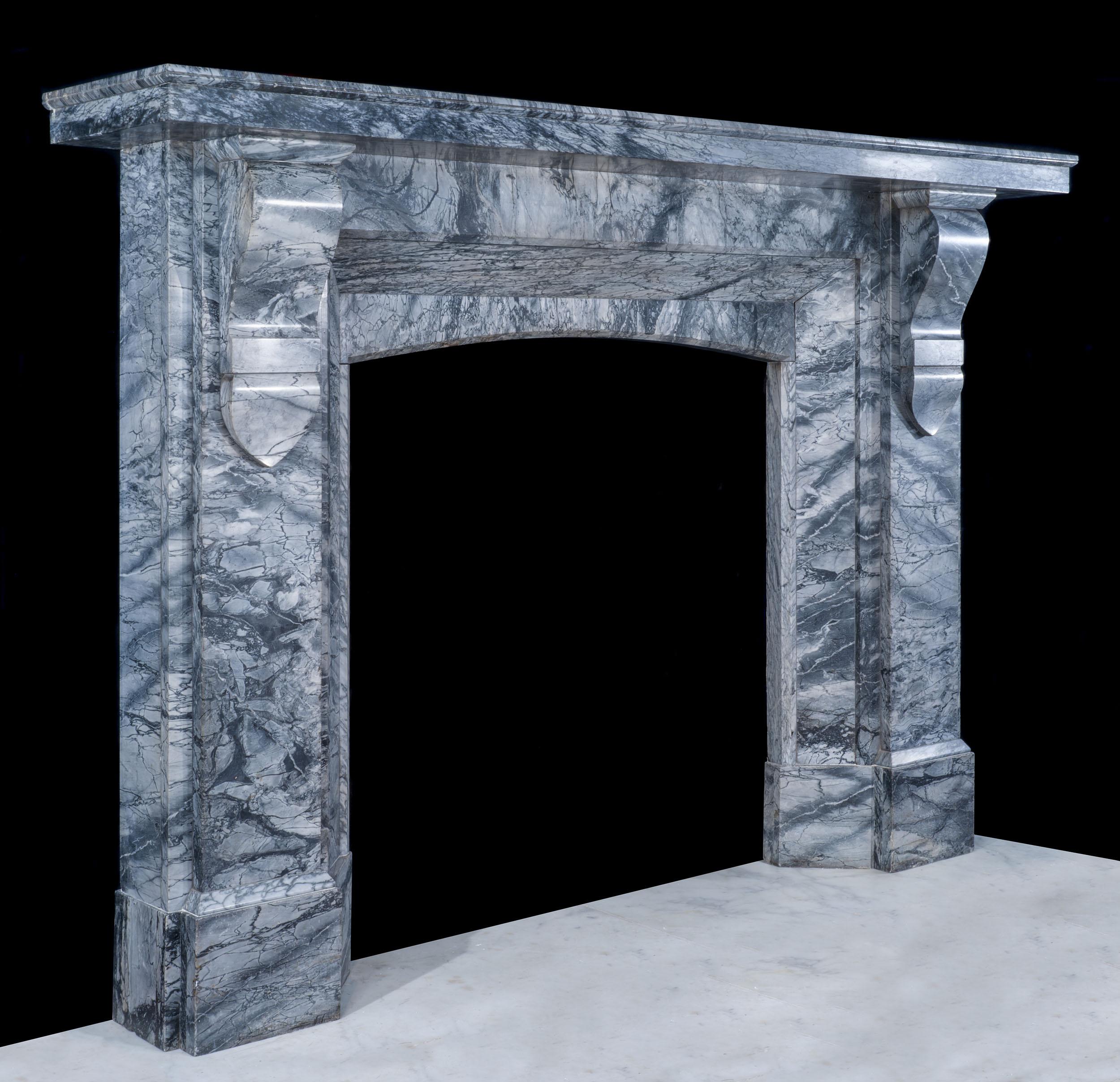 A really striking and large Victorian fireplace in Bardiglio Fiorito marble. The wide and deep shelf is supported by simple corbels on plan jambs. The angled inner returns are a really unusual feature and give this fireplace a substantial