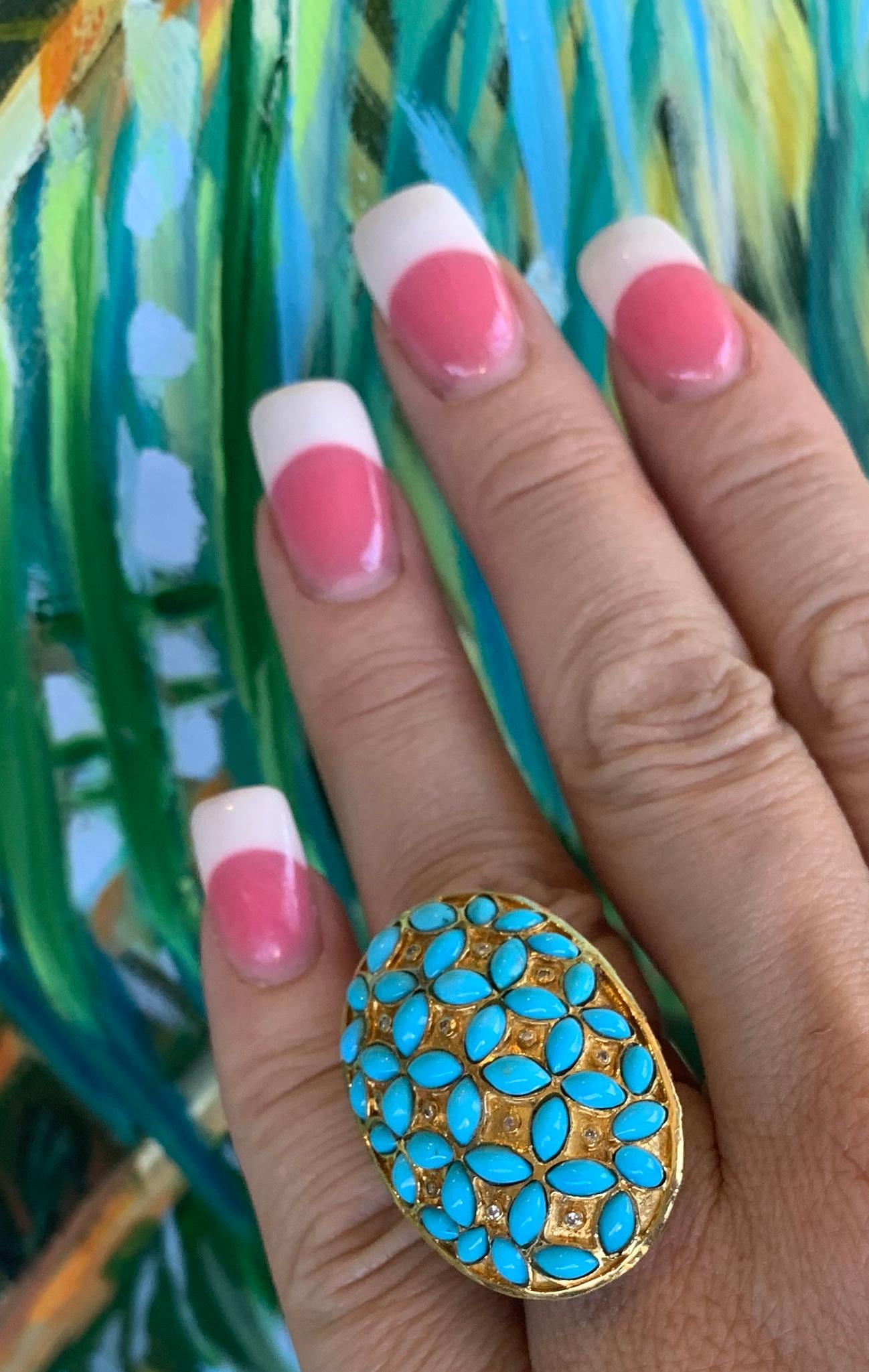 Magnificently large oval dome shaped 18 karat yellow gold cocktail ring from the 1970s features huge finger coverage.  39 tapered cabochon shaped, pure robin's egg blue Persian turquoise stones are accented by 14 round white diamonds bezel set in a