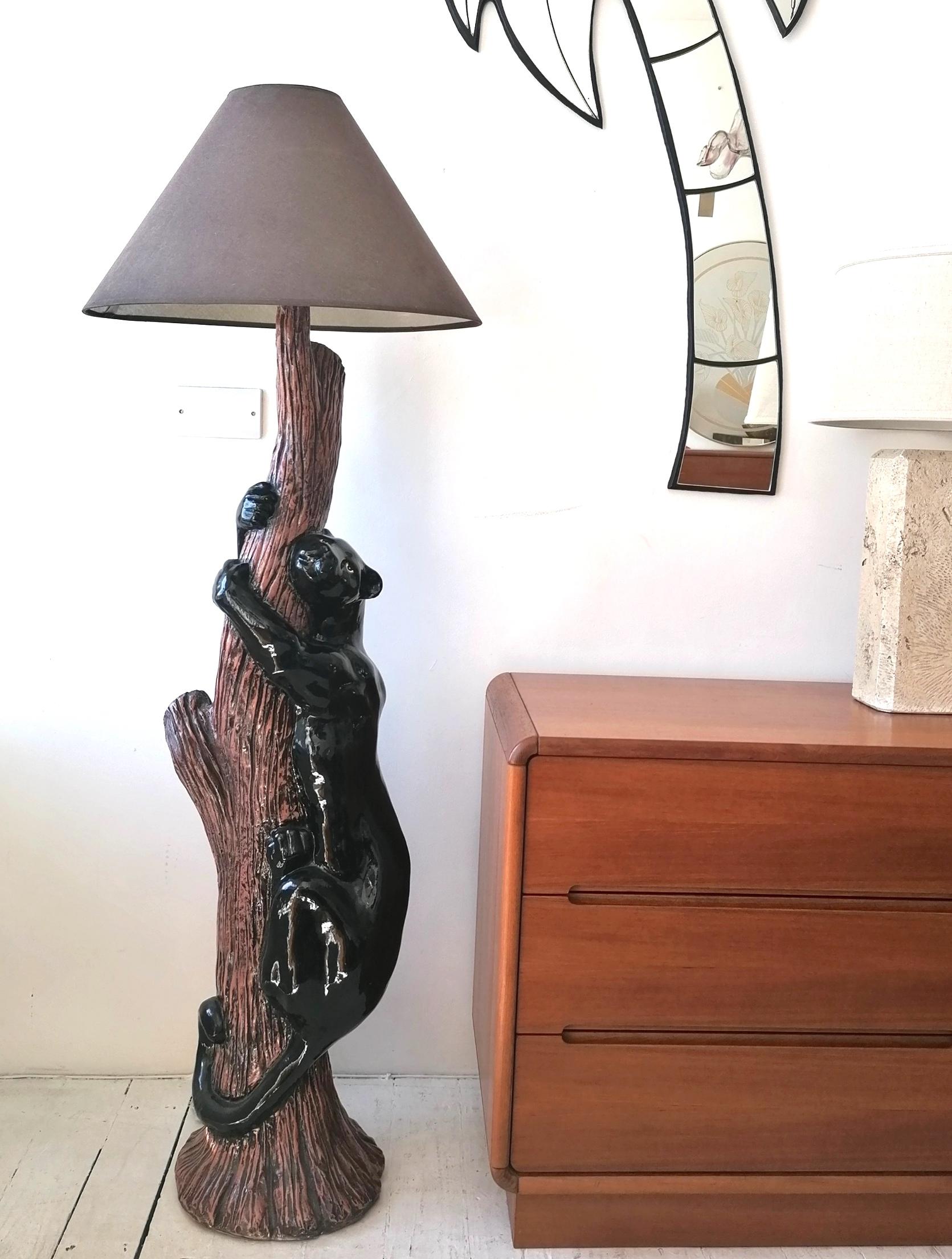 This huge & extravagantly kitsch 80s/90s American ceramic black panther, climbing a tree, floor lamp. Not an easy thing to find (we sourced it in Las Vegas), or bring back to England intact! 
Newly rewired (for UK) with black braided
