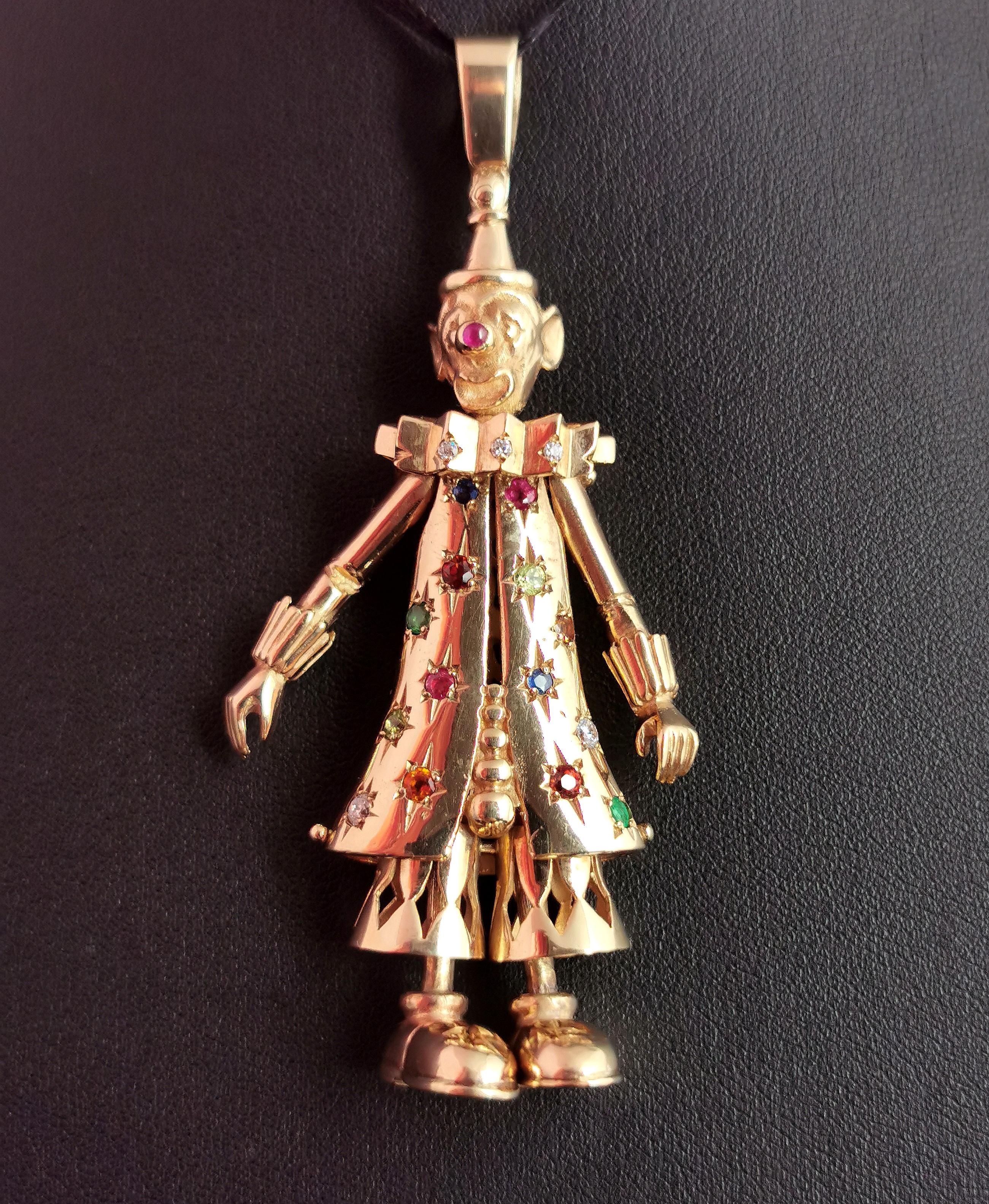 An incredible, huge vintage 9ct yellow gold articulated clown pendant.

A classic favourite from the 90s this clown pendant has movable limbs and is set with paste, Sapphire, Garnet, Peridot, emerald and Ruby stones to the front, nose and collar.

A