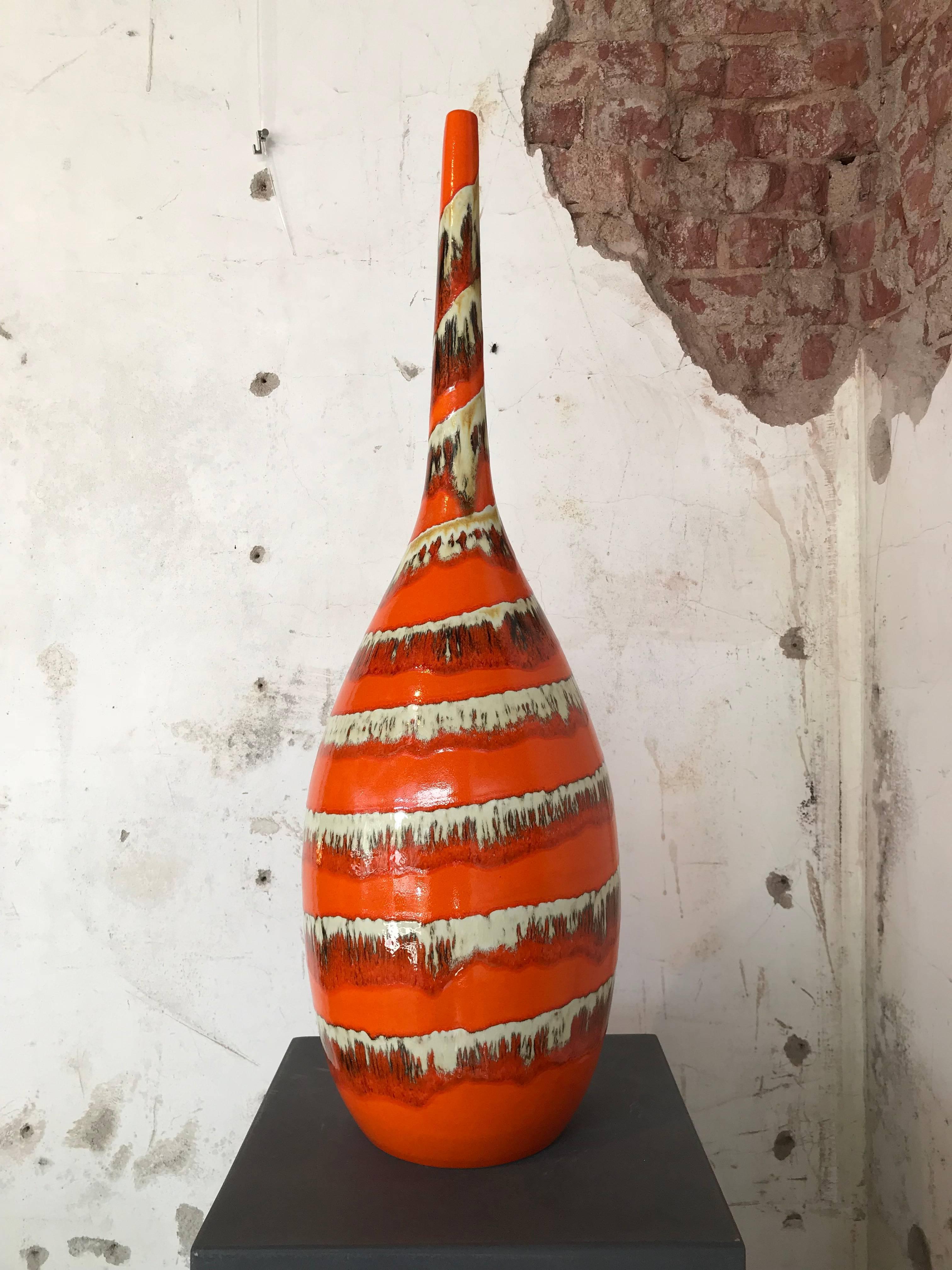 A stunning vintage, large-scale bottle form vase, produced midcentury in Germany, comes in deep orange lava glazed ceramic. This vase remains in very good condition, minor wear to base consistent with age.

Measures: Height 70 cm!

 