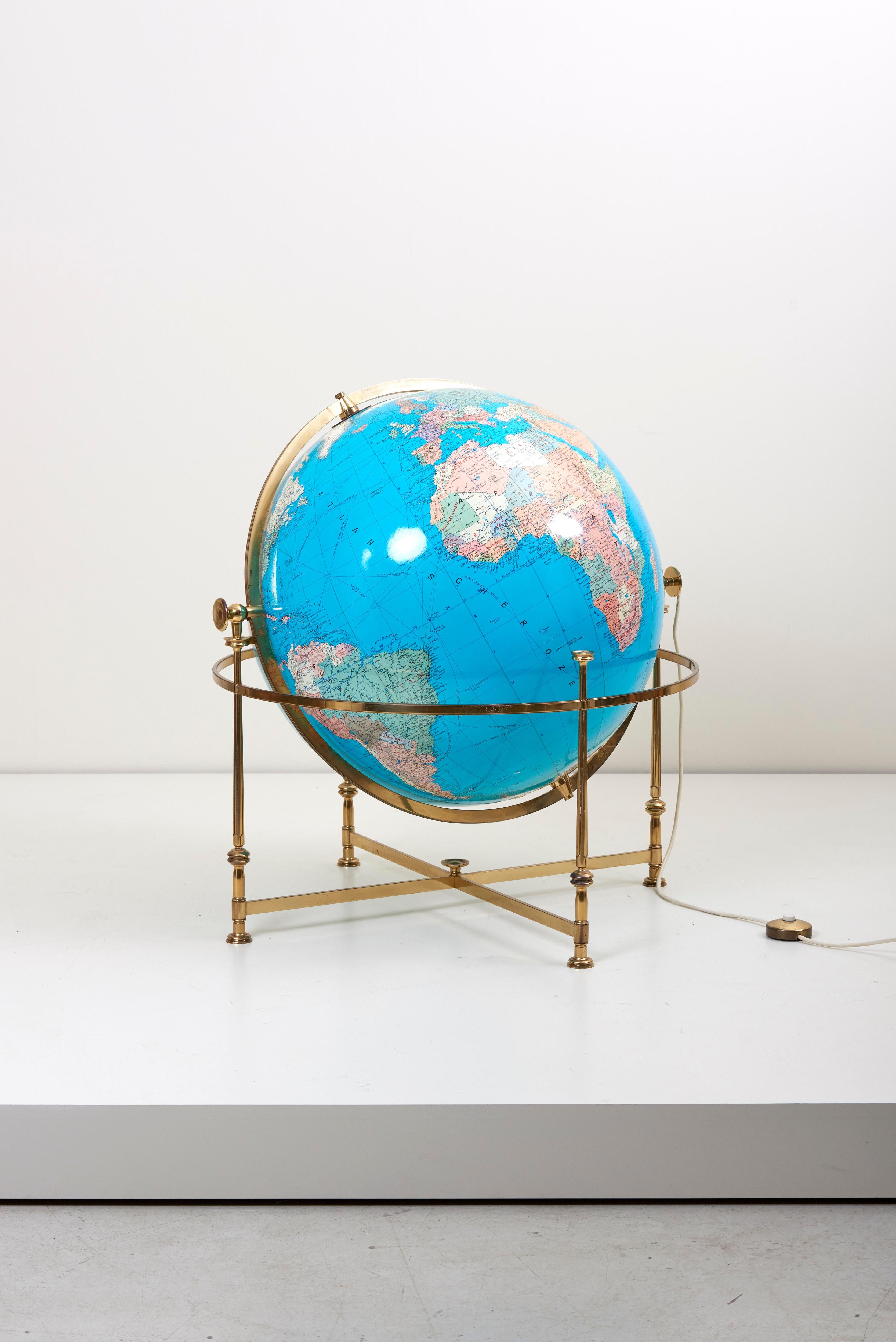 Merveilleux et rare globe illuminé avec un support en laiton. Le globe est rotatif et réglable en hauteur.