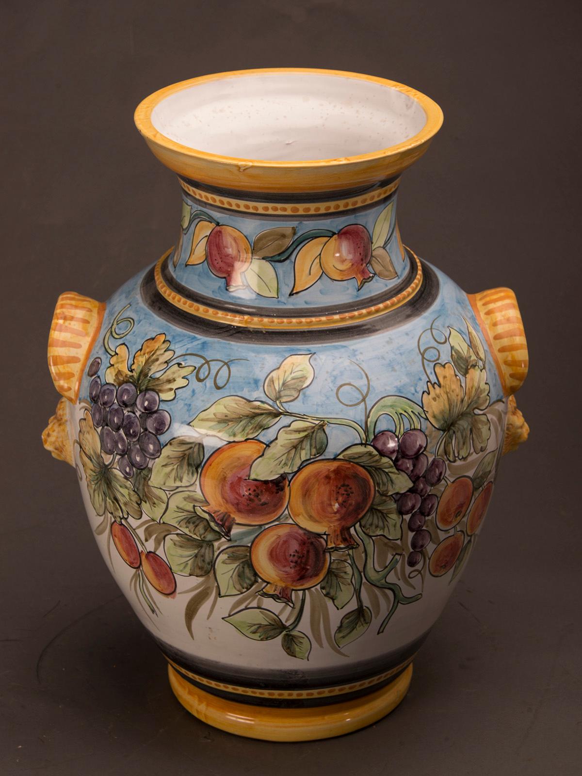 A beautiful huge vintage Italian hand painted terra cotta urn vase featuring an abundance of fruits including grapes and pomegranates. This vase may contain both dried and living material or may be used for display on its own. We have two available
