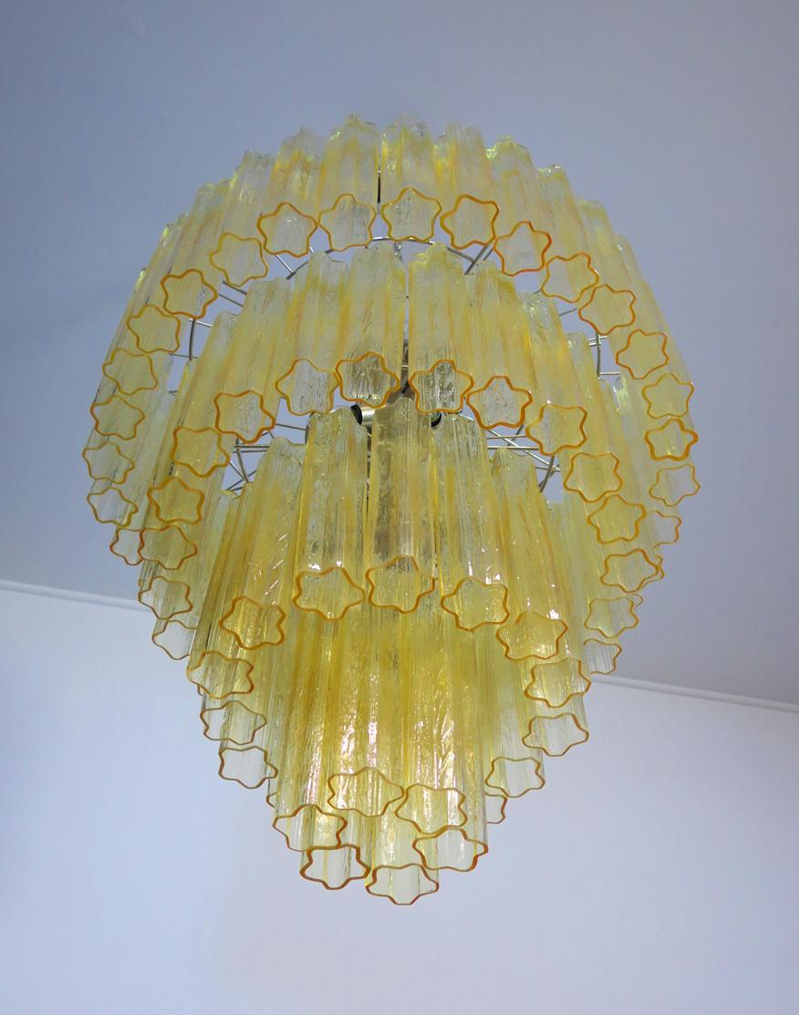 Italian vintage chandelier in Murano glass and nickel plated metal structure on 4 levels. The armor polished nickel supports 78 large light amber glass tubes in a star shape.
Period:	Late XX century
Dimensions:	70,90 inches (180 cm) height with