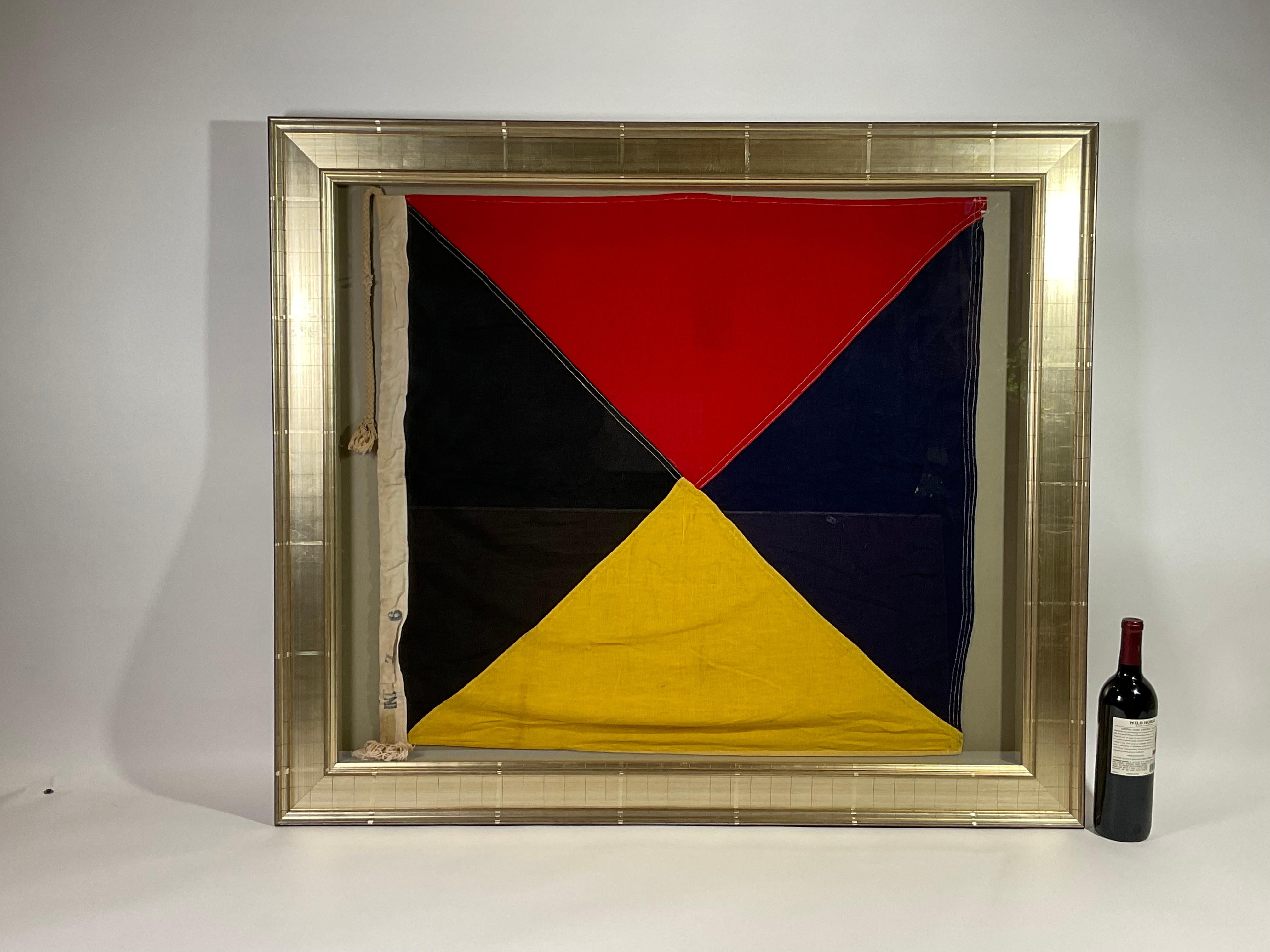 Framed maritime signal flag representing the letter “Z”, “ZULU” in the international code of signals. This authentic and ocean used pennant is made of individual panels of black, blue, red and yellow. Fitted to a heavy canvas hoist band with