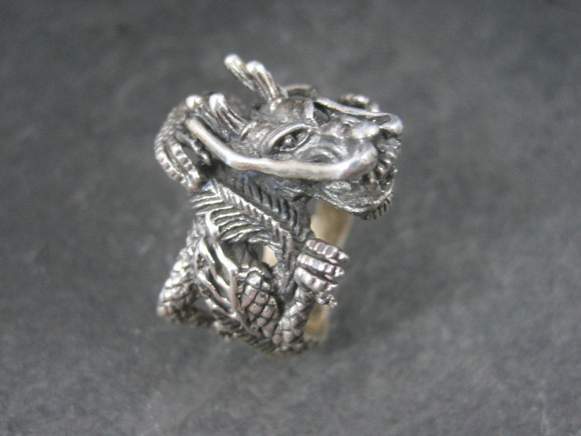 This amazingly detailed dragon ring is beyond gorgeous. It is definitely a conversation starter.

It is 20.7 grams of solid 925 sterling silver.

Size 10.5

The face of this ring measures 1 1/16 inches north to south with a rise of 3/8 of an inch