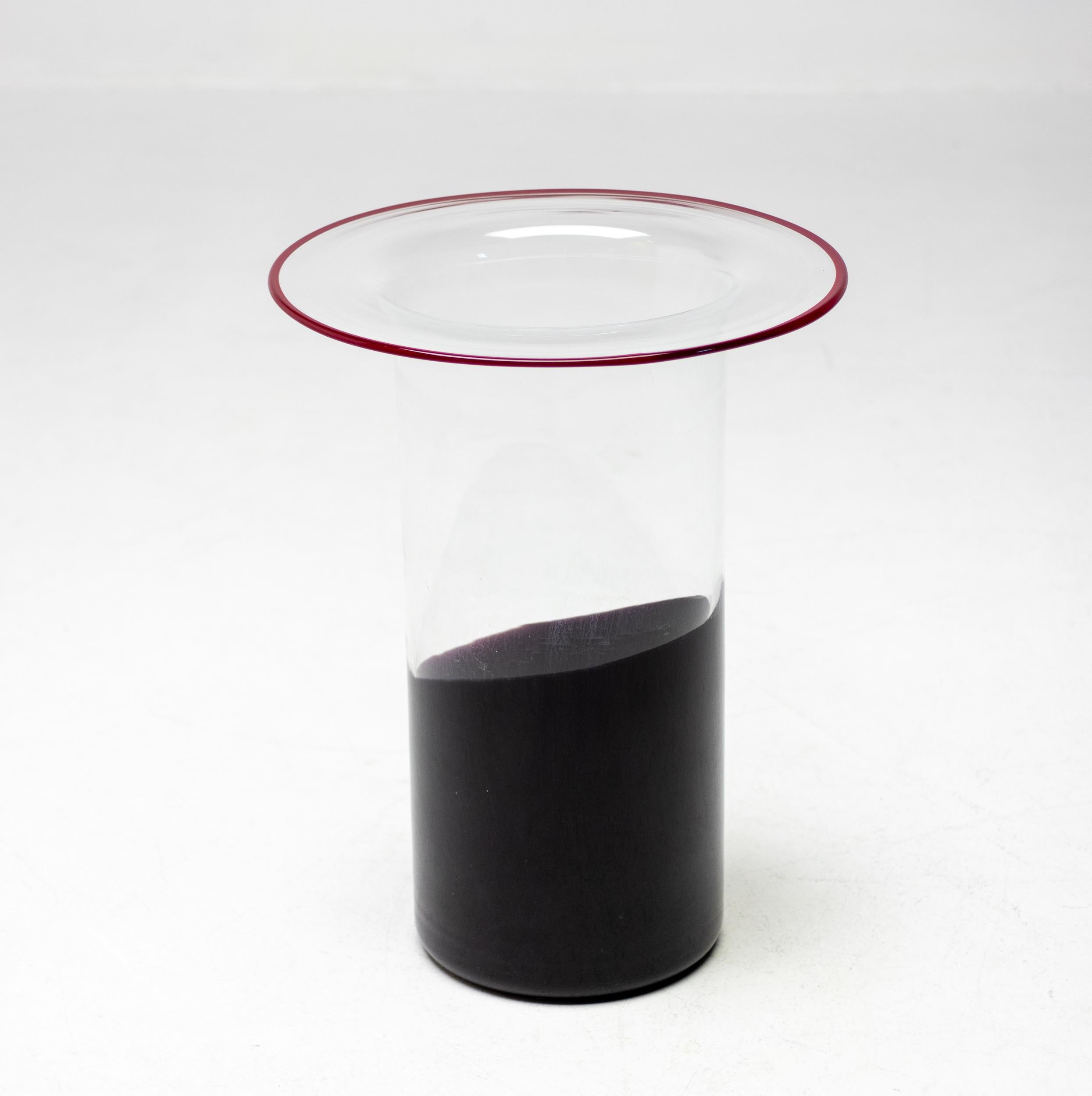 Beautiful Vistosi cylinder hat shaped vase in clear glass with partial black glass at the bottom and a Vistosi trademark red glass edge. Designer Alessandro Pianon started working for Vistosi in 1956 and founded his own design office in 1962.