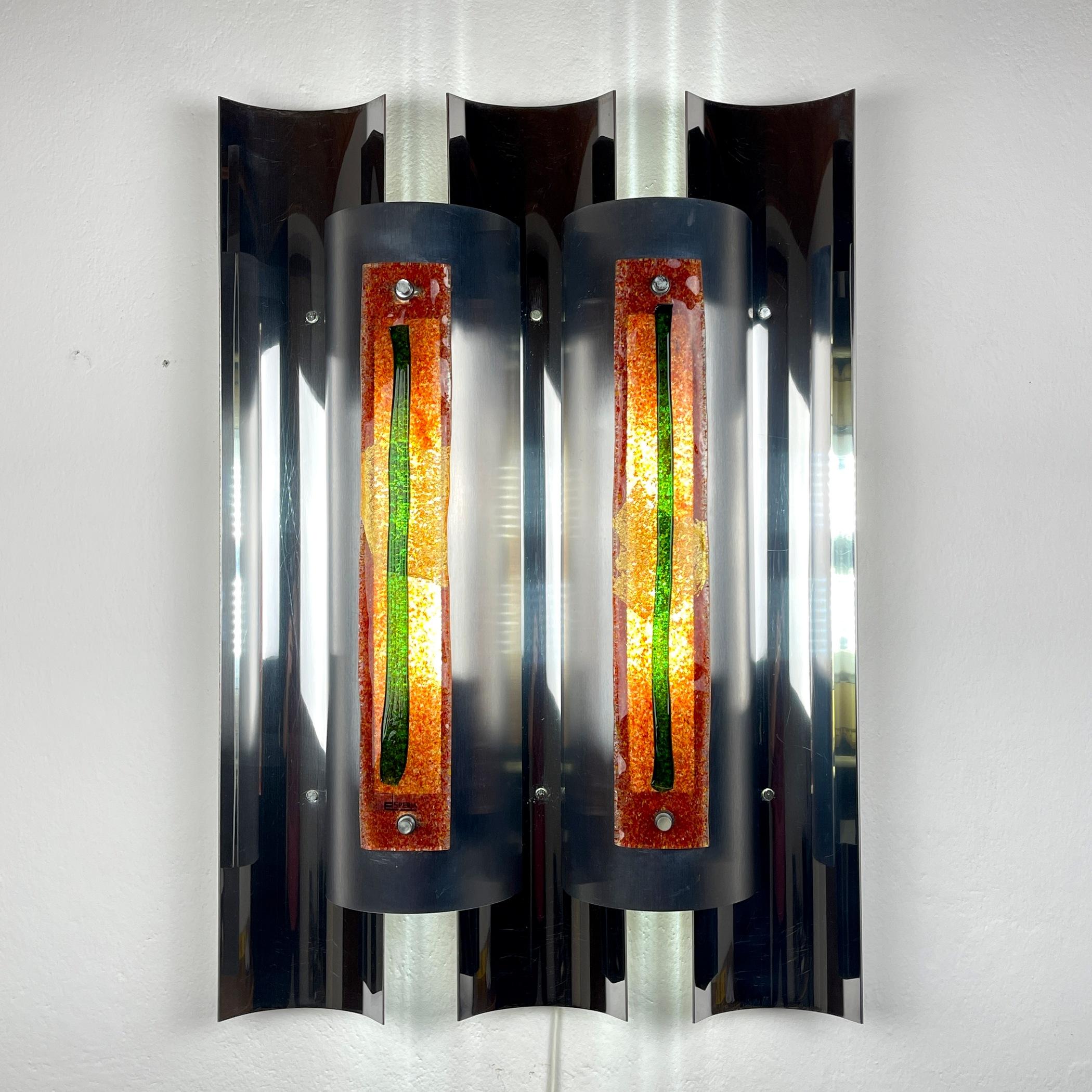 Introduce a statement piece to your interior with the imposing wall lamp designed by Angelo Brotto for Esperia in Italy during the 1970s. This substantial fixture embodies the essence of mid-century modern design and represents a quintessential