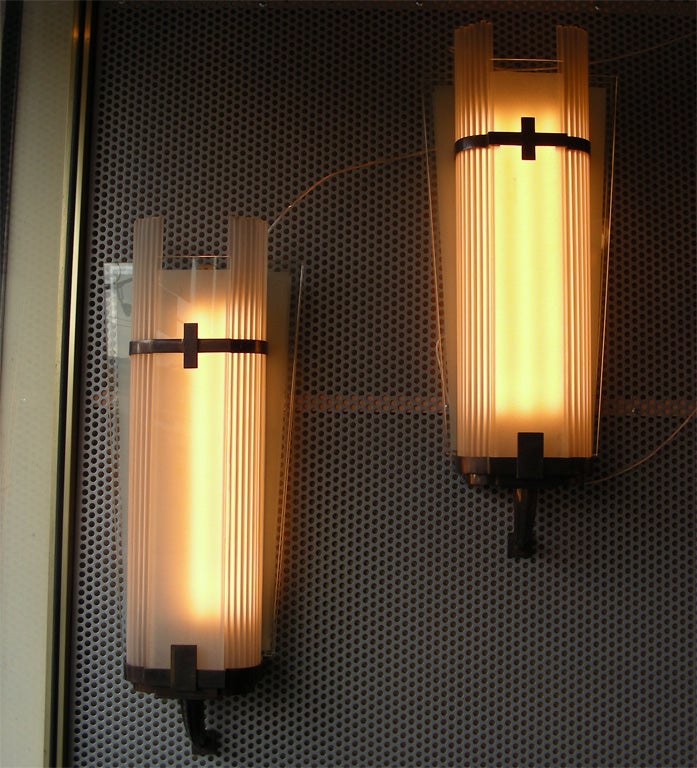 Two 1935 sconces by Gênet et Michon in patinated bronze, frosted glass, with neon light. One more pair available, but price quoted is for one pair.