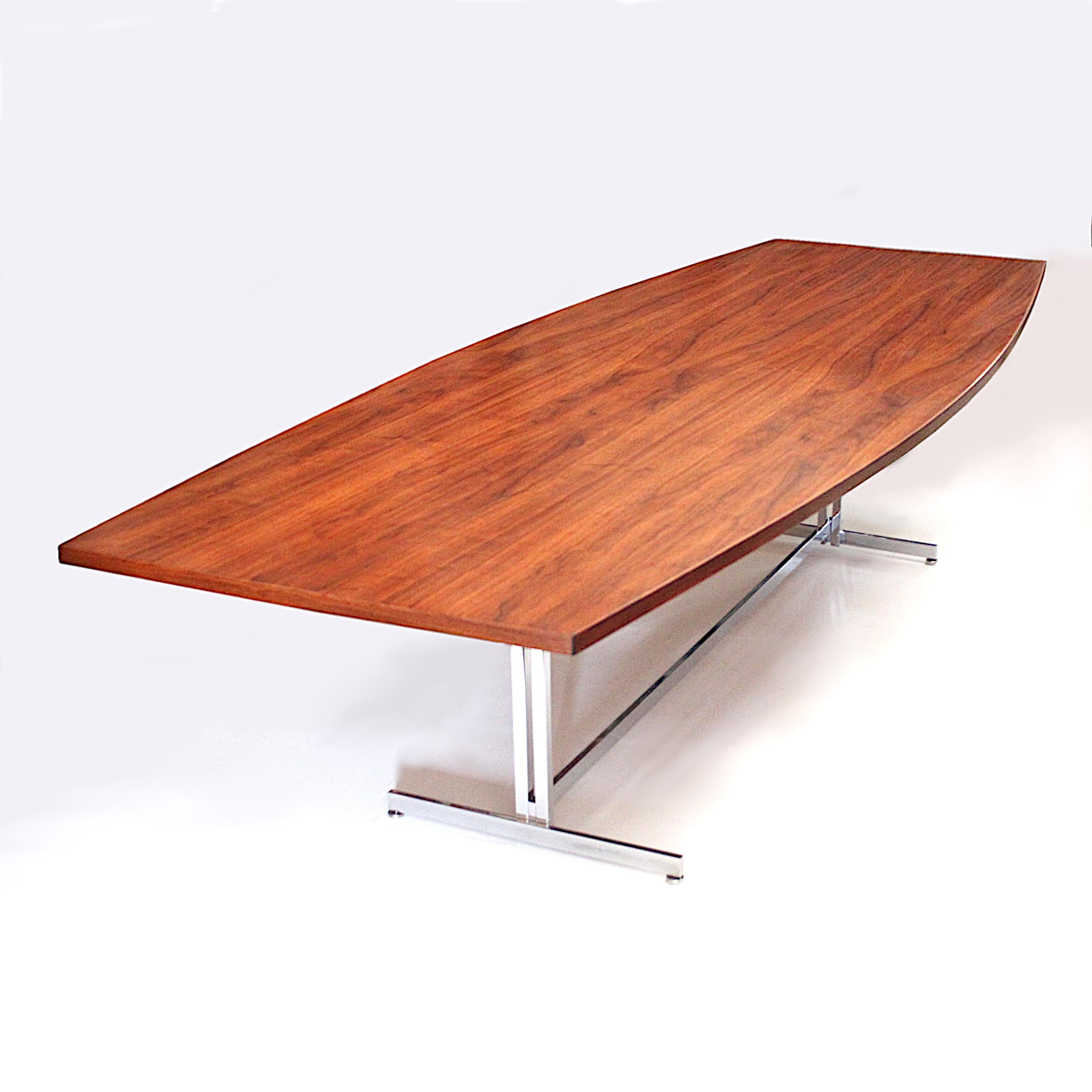 This spectacular table is a Hugh Acton original design made by Vecta Group. The huge boat-shaped top measures an impressive ten feet long and features gorgeous matched-grain walnut veneer. The unique trestle base gives the table a wonderful