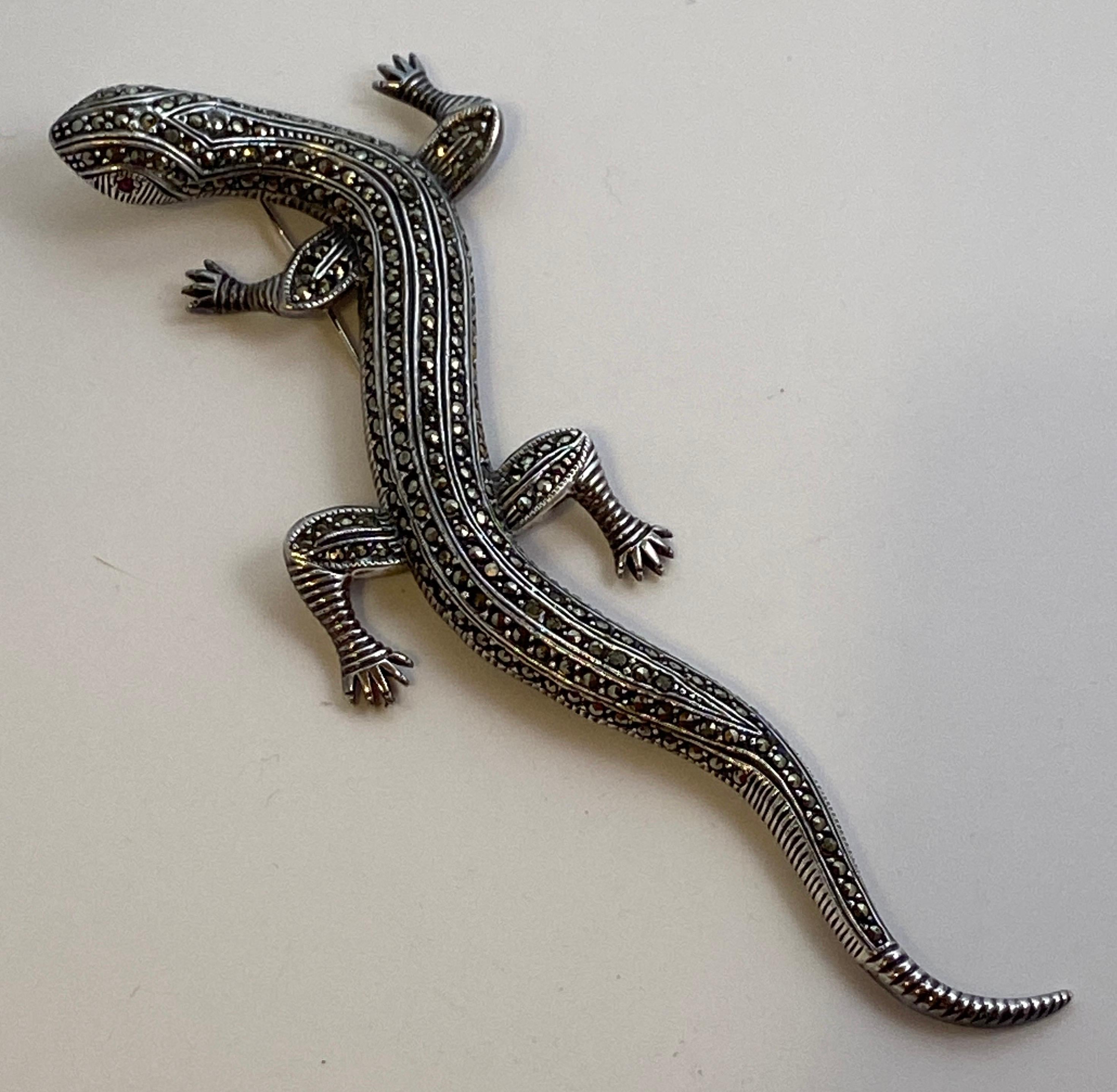 This huge whimsical sterling silver lizard brooch is accented throughout with micro crystals. The length measures 6 1/4 inches. The width measures 2 inches. Made in U.S.