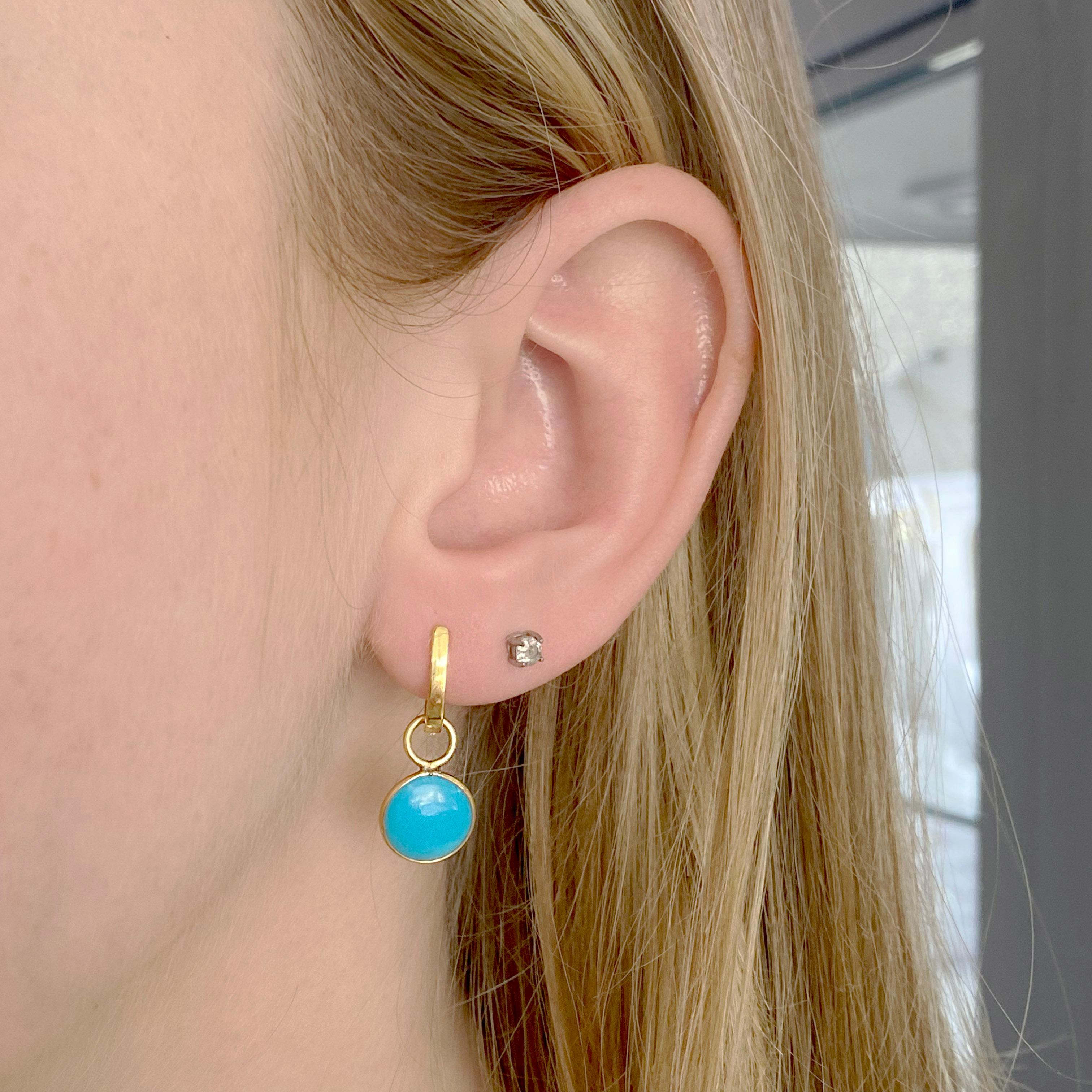 The 18k yellow gold huggie earrings are adorable by themselves or with the Persian turquoise charm. The Persian turquoise is the rarest of all types of turquoise and ghastly the most pure color. These earrings are rich looking and very classy.
The