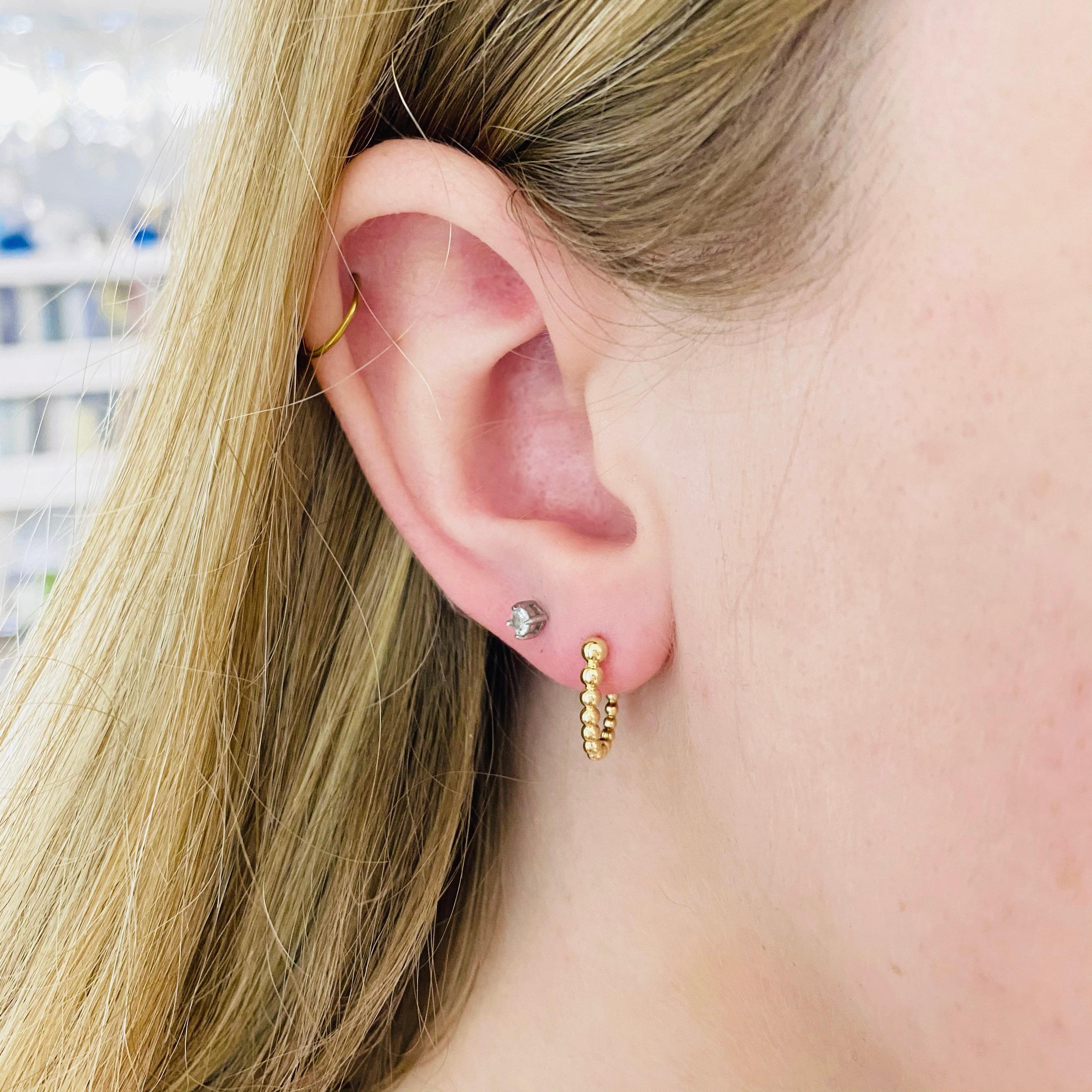 These stunning  Gabriel & Co. 14k yellow gold beaded detailed huggie hoops provide a look that is both trendy and classic. These earrings are a great staple to add to your collection, and can be worn with both casual and formal wear.  These earrings