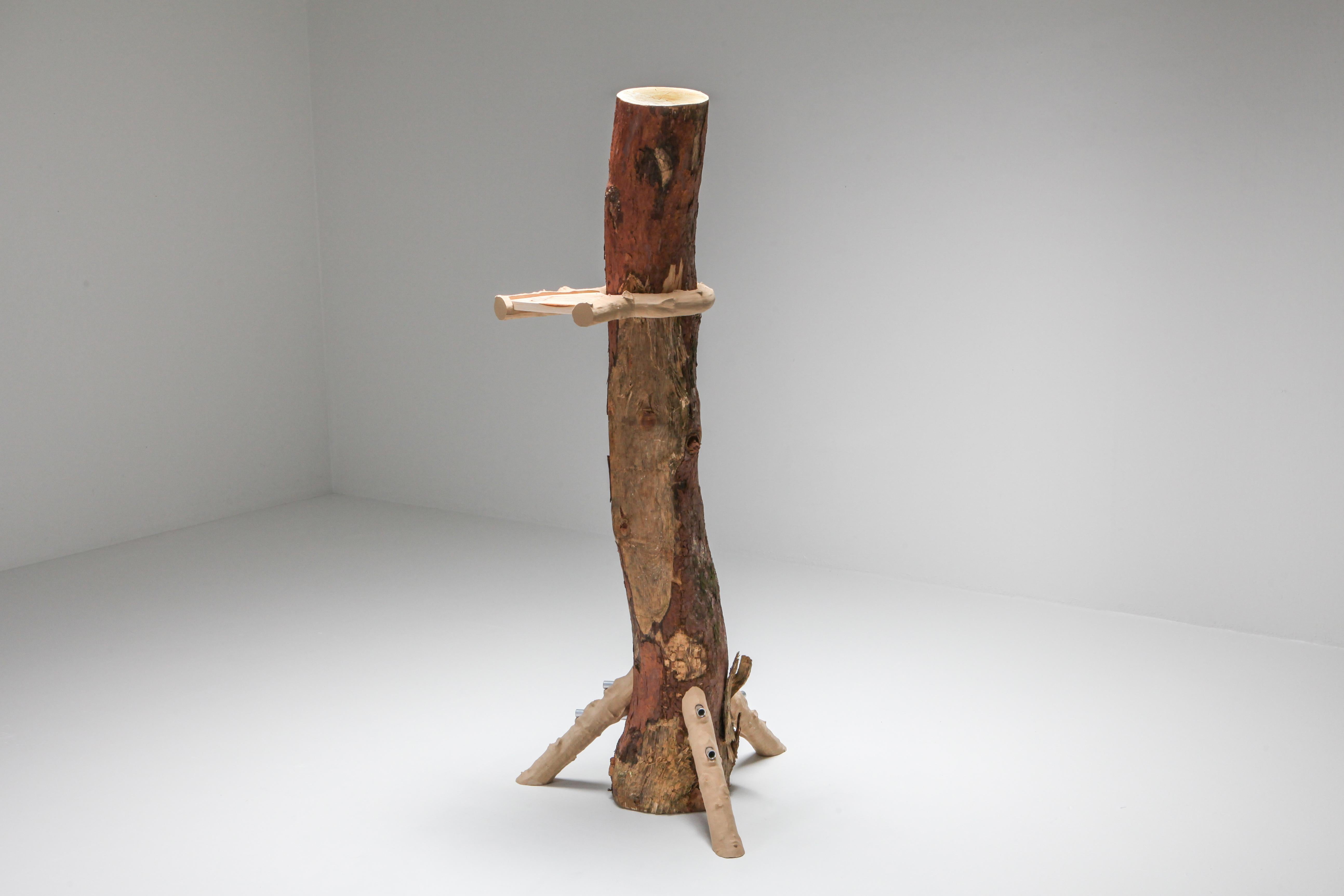 The “Hugging and Poking Shelf” functional art piece starts a dialogue about nature and construction. The seemingly unstable tree trunk is held up by three 3D printed branches, from which six tubes poke into the tree trunk. Apart from their outer