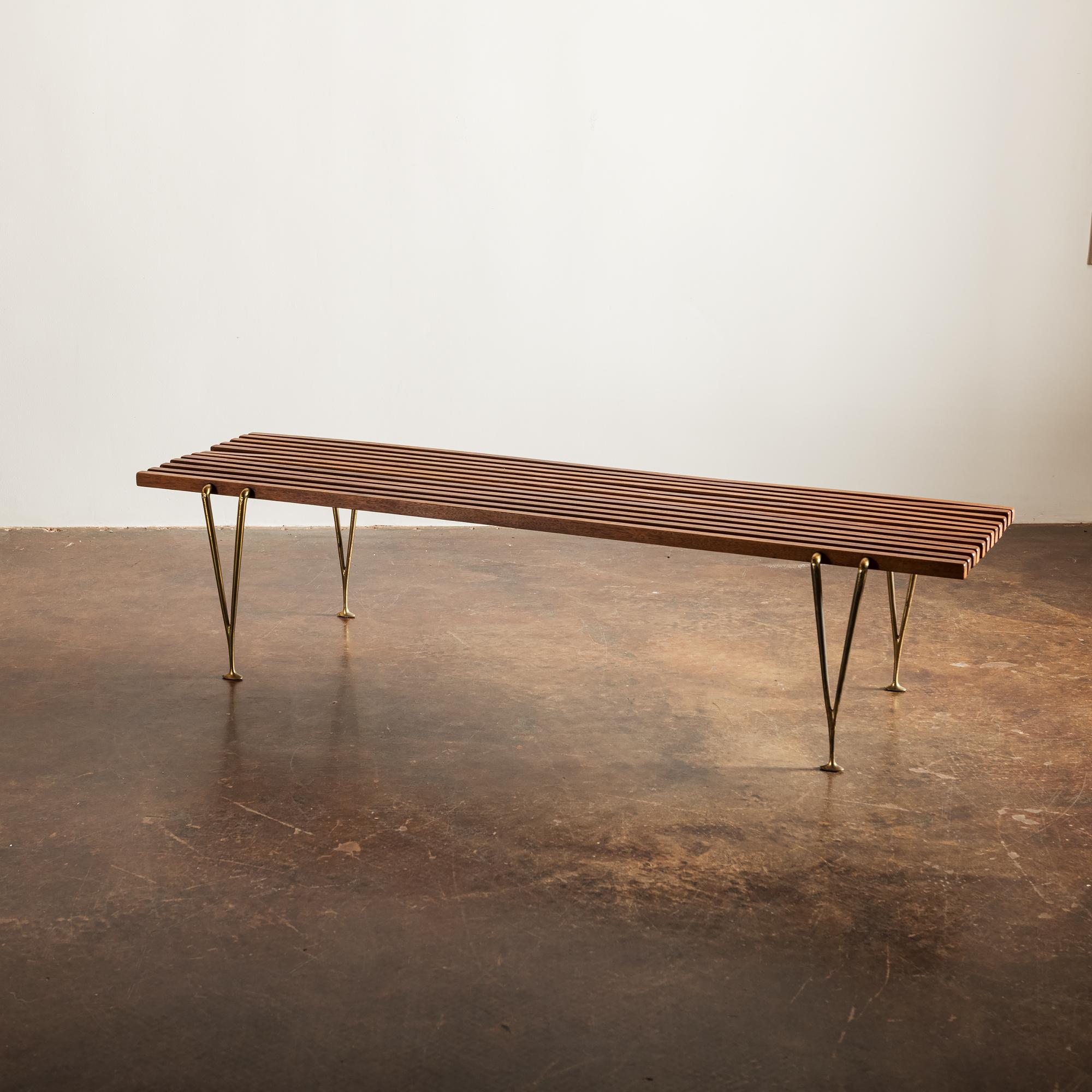 Beautiful bench featuring walnut slats connected by elegant V-shaped cast brass legs, by Hugh Acton, USA, 1954.