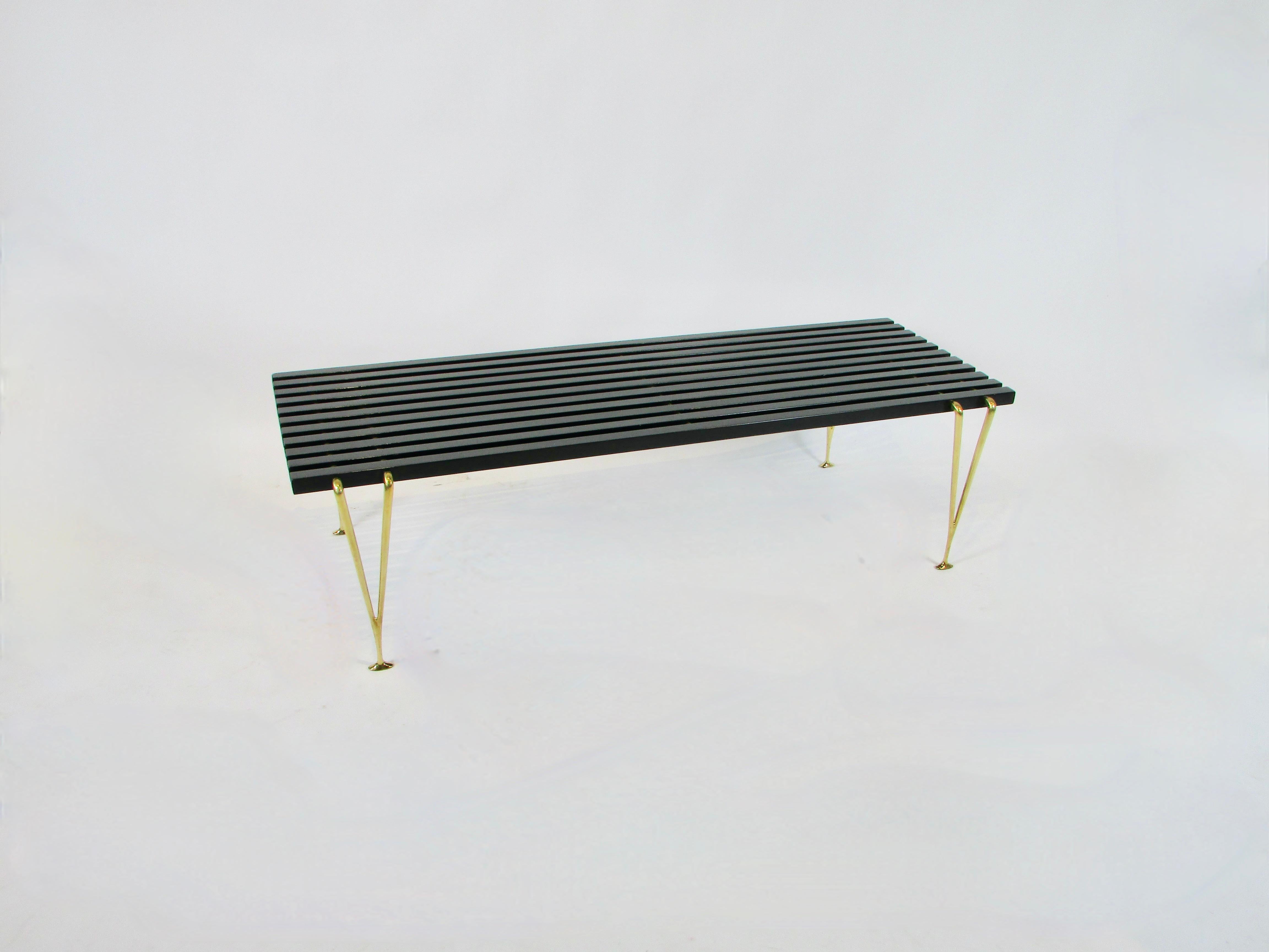 Slat  bench, designed and produced by Hugh Acton studio  / Hugh Acton Inc. Kalamazoo, Michigan, c. 1954. Black lacquered slats joined together with brass rod supported by polished brass legs .   