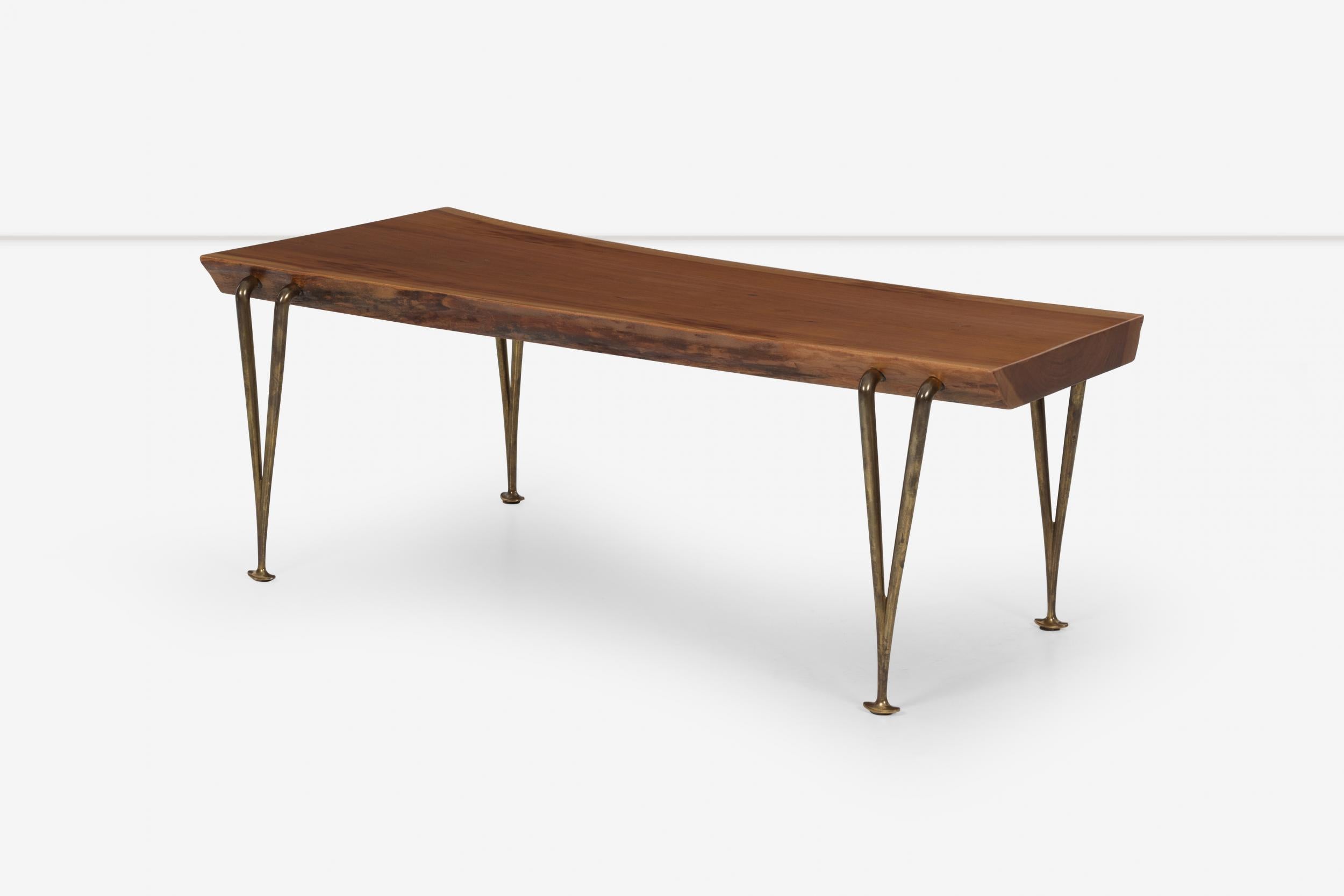 Hugh Acton Free-Edge bench, Variation of Acton’s slat bench featuring a free-edge walnut plank with solid brass legs. Acton was developing a number of bench designs in his studio barn using free-edge wood planks. 
Depth of slab largest 20