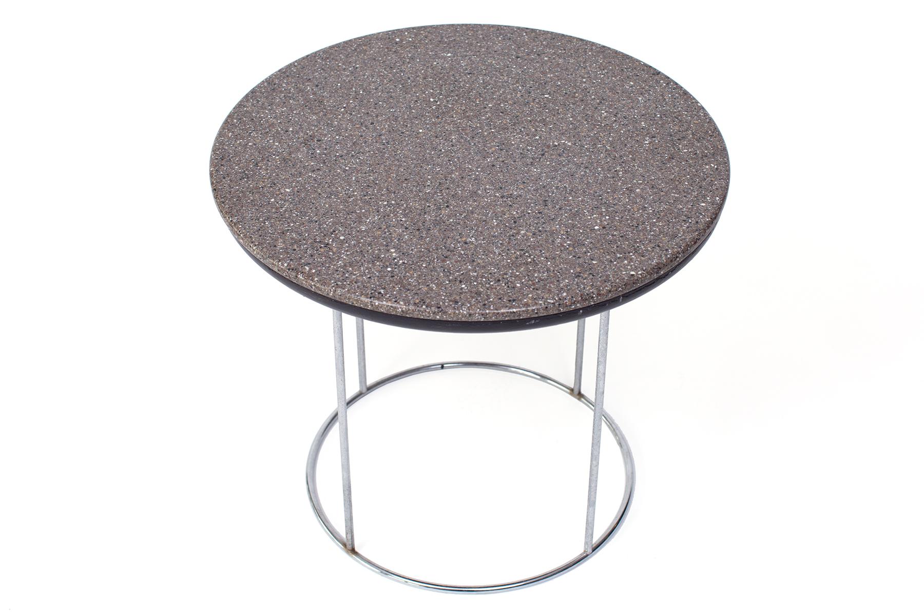 Hugh Acton chrome and granite side table circa early 1970s. This example has a finely grained grey granite top and sleek chrome base.