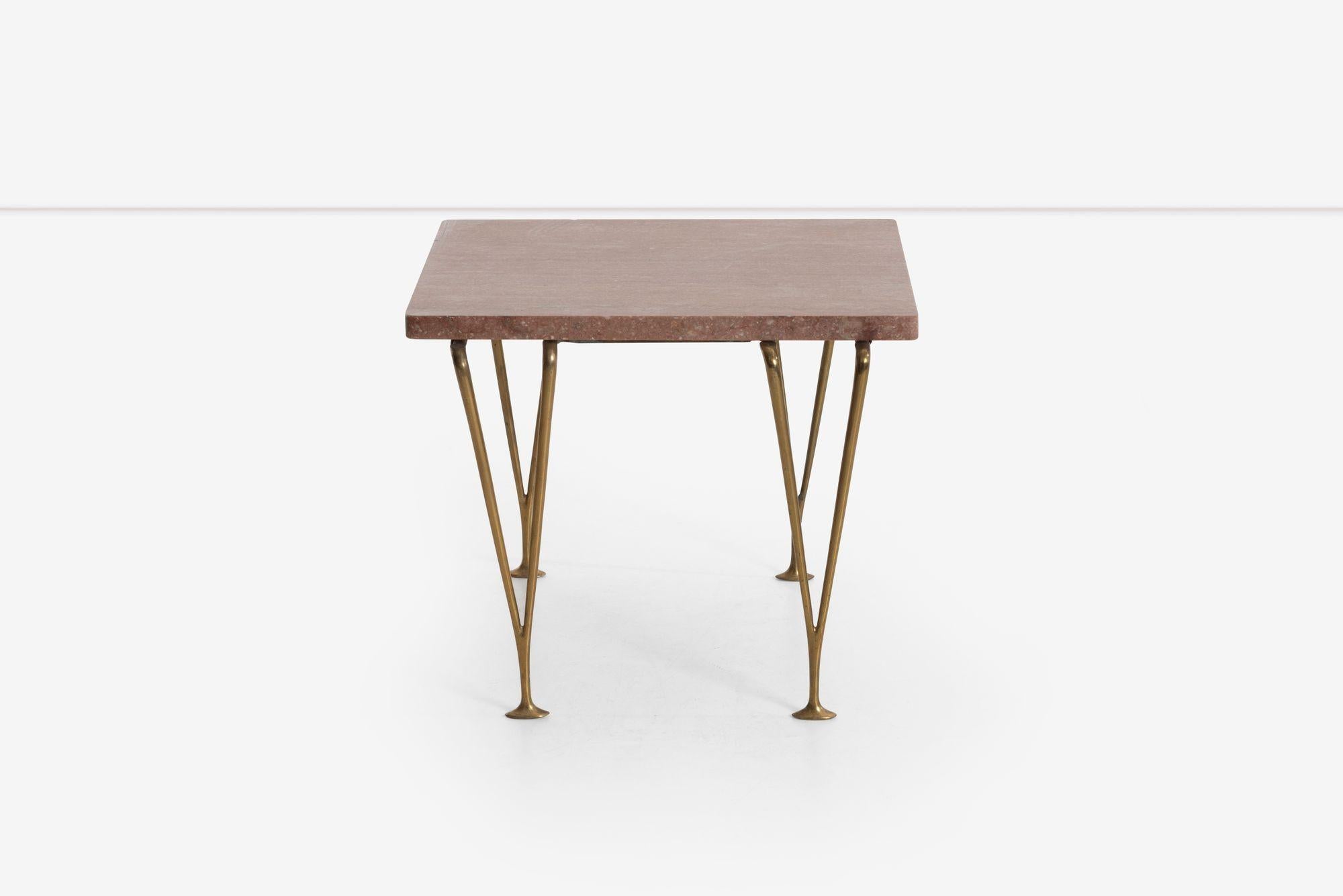 Hugh Acton unique side table, from the residence of Hugh Acton, Birmingham, Michigan.
Similar to the iconic production benches, V legs in solid brass with a pink travertine top.